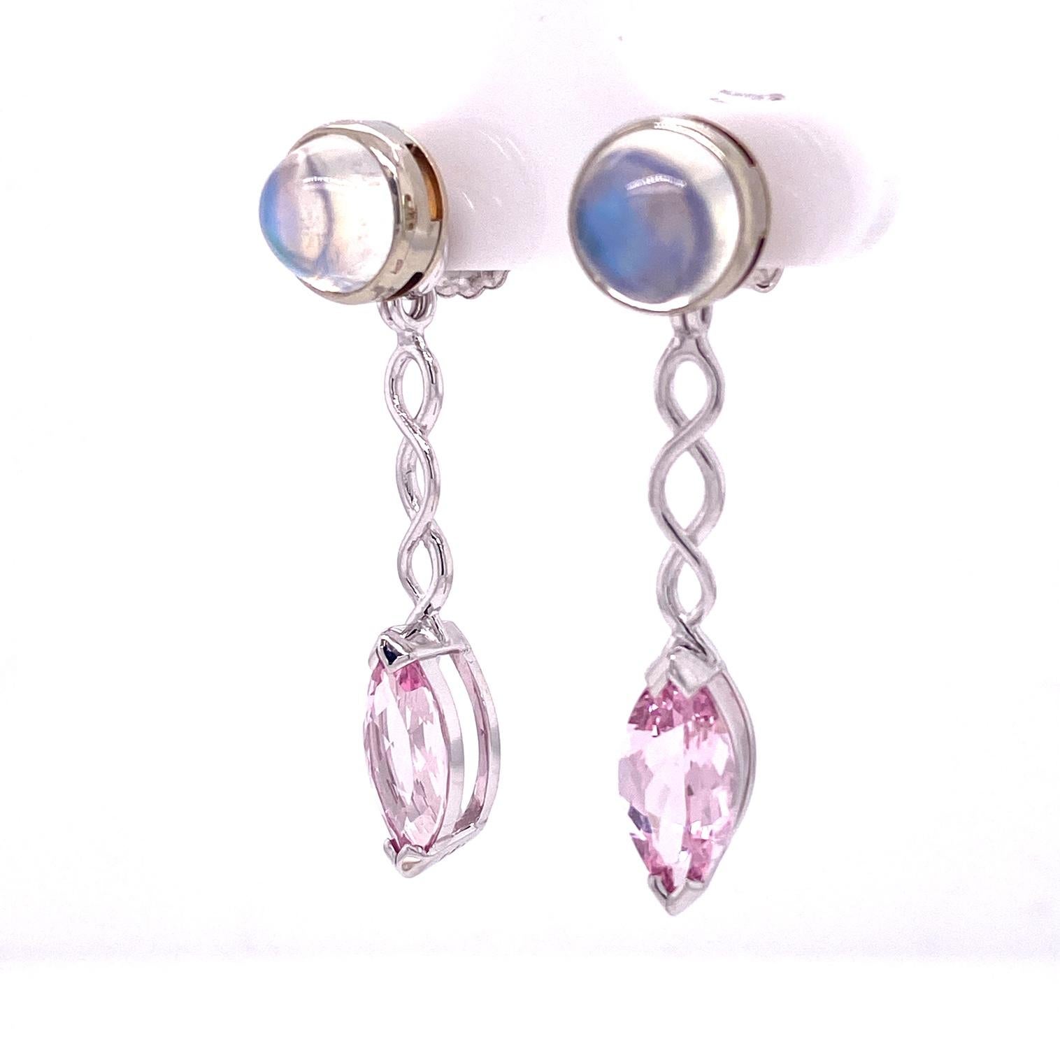 A pair of 18k white gold stud earrings bezel set with round cabochon rainbow moonstones, 4.59 total carat weight, and a pair of 18k white gold jackets set with 12mm x 6mm marquise morganite jackets, 3.02 total carat weight. These earrings were made