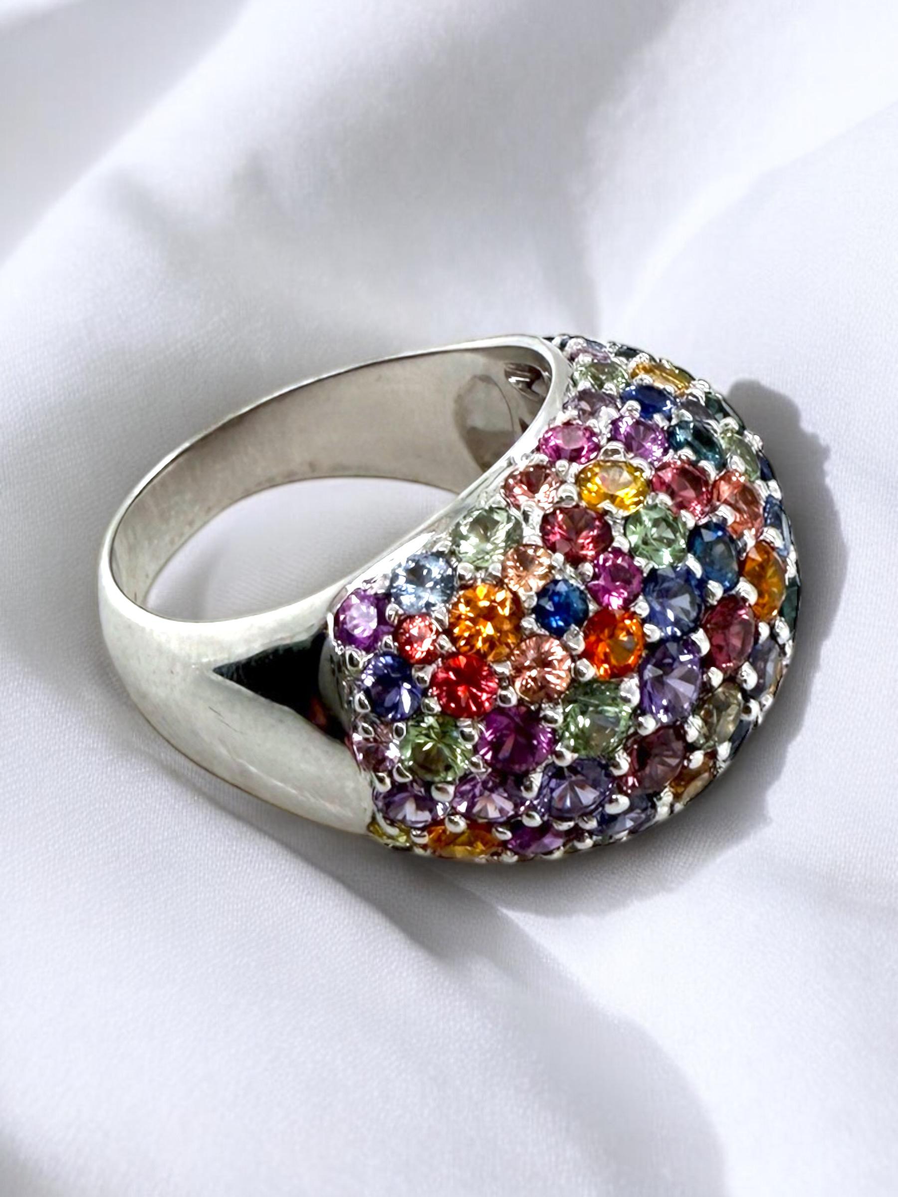 We are absolutely loving this unique beauty!!
How do you not love the use of sapphires in every color of the rainbow?

Ring Details
Material: 18K White Gold
Head Height: 9.5mm
Head Width: 16.8mm
Shank Width: 4.4mm
Weight: 13.2 Grams
Finger Size: 8