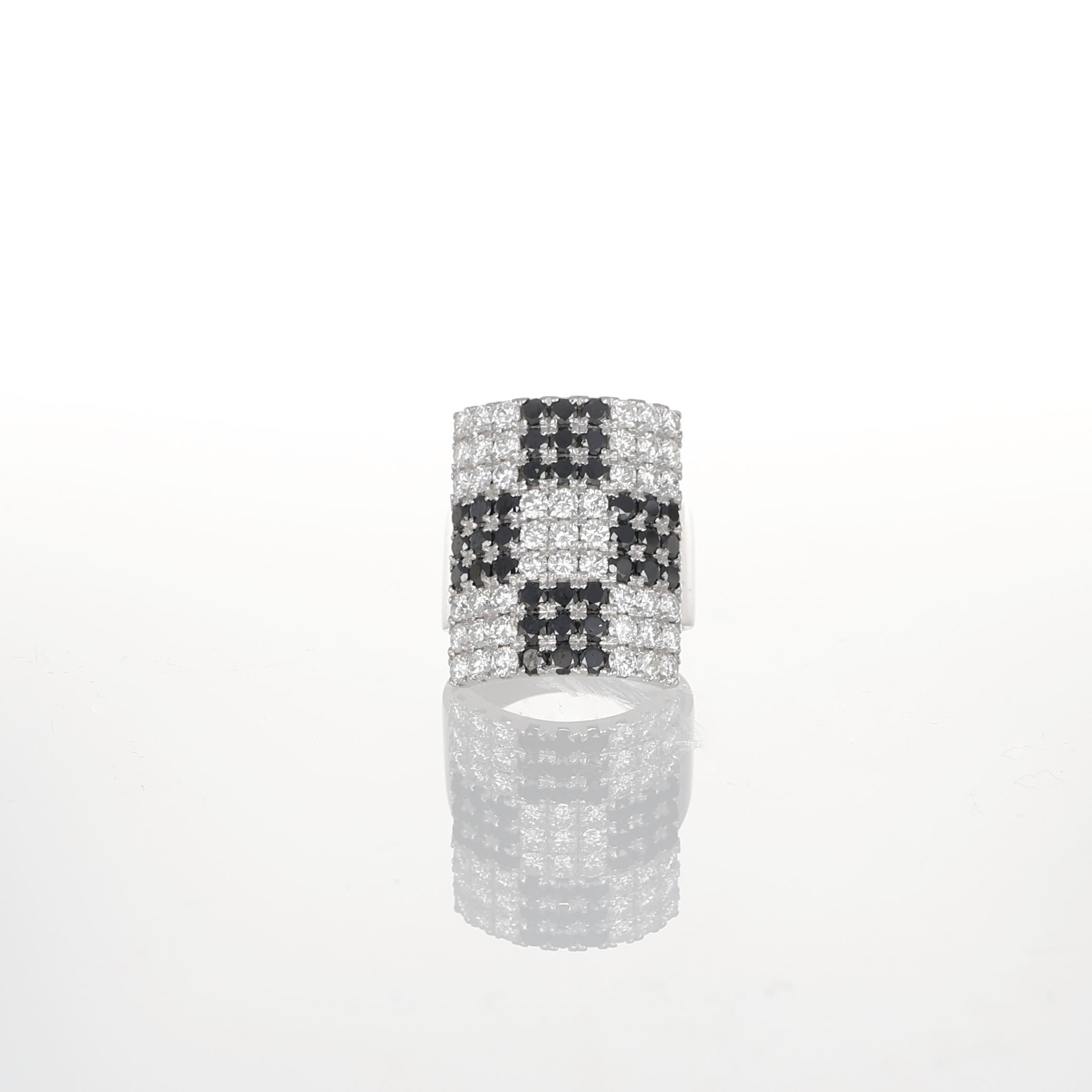 A bold geometric statement, this 18K white gold ring features a striking rectangular design, fully pavé-set with natural brilliant-cut diamonds. The checkerboard pattern is created by 2.15 carats of white diamonds contrasting against 1.91 carats of