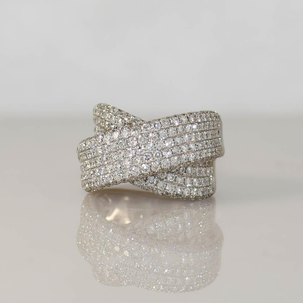 Ribbon style diamond ring in 18k white gold.
Stamped 750 and weighs 15.4 grams.
The diamonds are round brilliant cuts, 4.00 total carats, G color, mostly VS clarity, some Si. Very good cuts.
There is fancy gallerywork inside the ring.
The ring