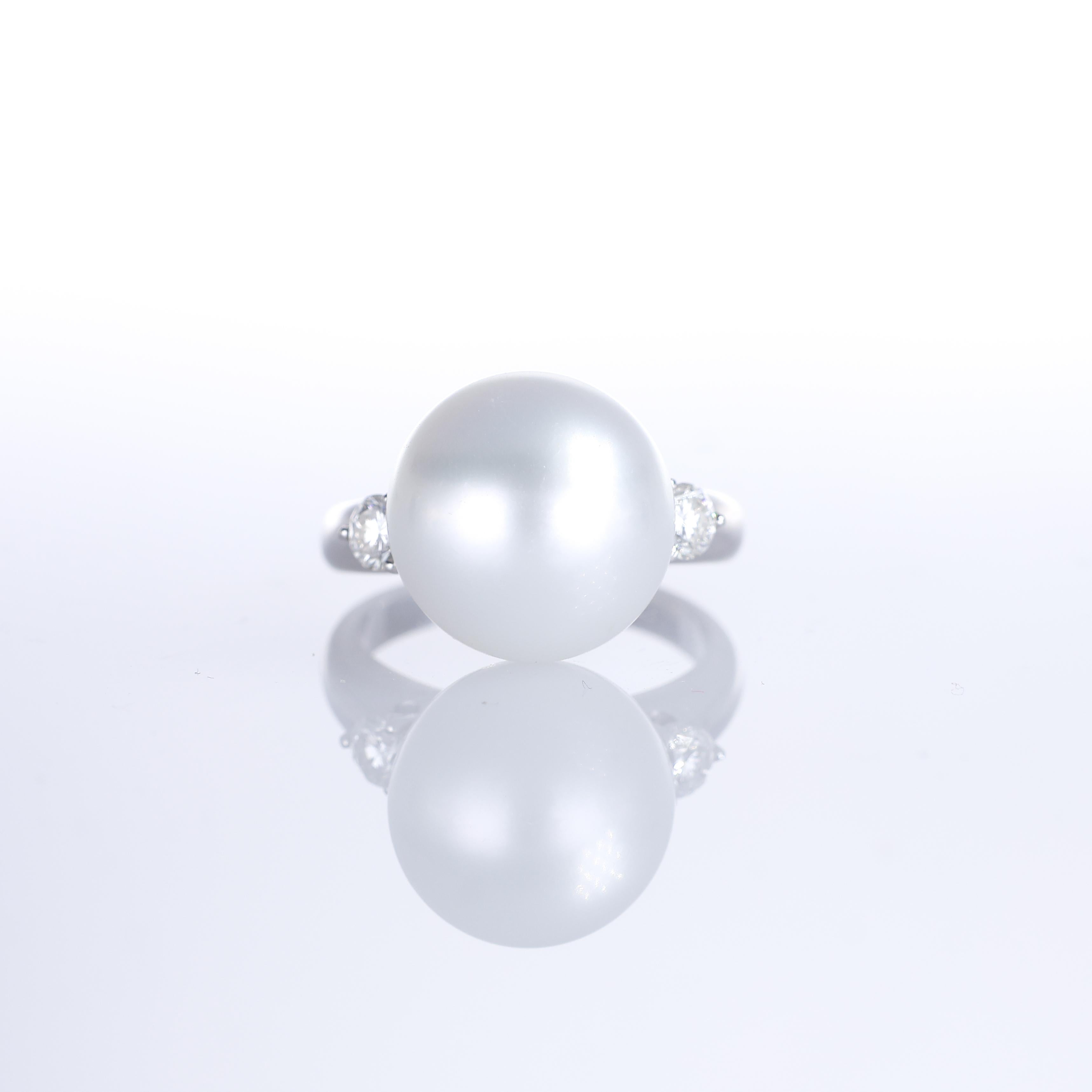 An elegant 18K white gold ring featuring a luminous 13.5mm white pearl, accented by two brilliant-cut natural diamonds totaling 0.39 carats. The refined design highlights the pearl’s soft luster while the diamonds add a touch of brilliance, creating