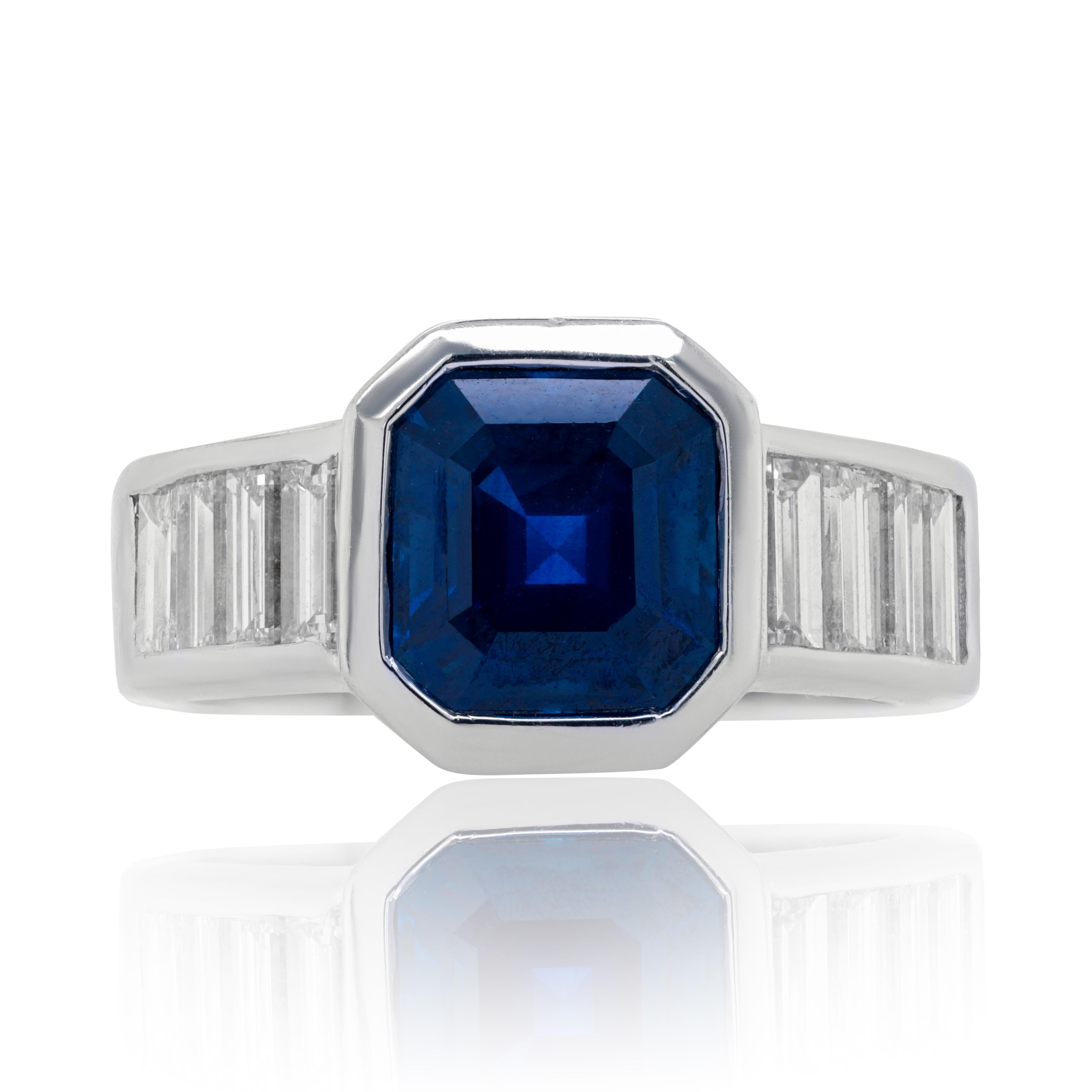 18k white gold sapphire and diamond ring features 3.31 ct asscher cut share sapphire and 1.15 carats of emerald diamonds on the side all in bezel setting
