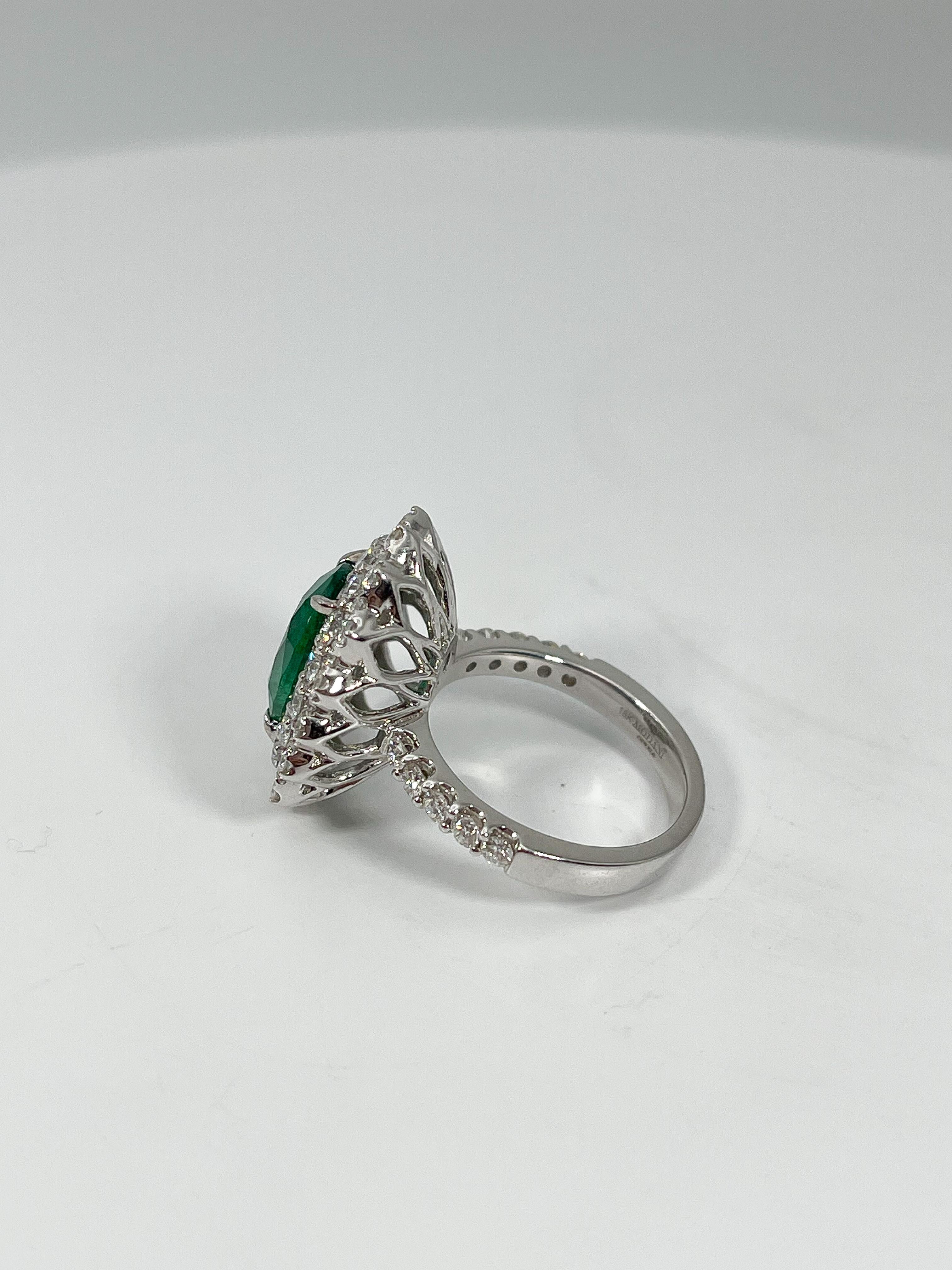 Oval Cut 18K White Gold Ring with 3.93 CT Emerald and 1.84 CTW Diamonds For Sale