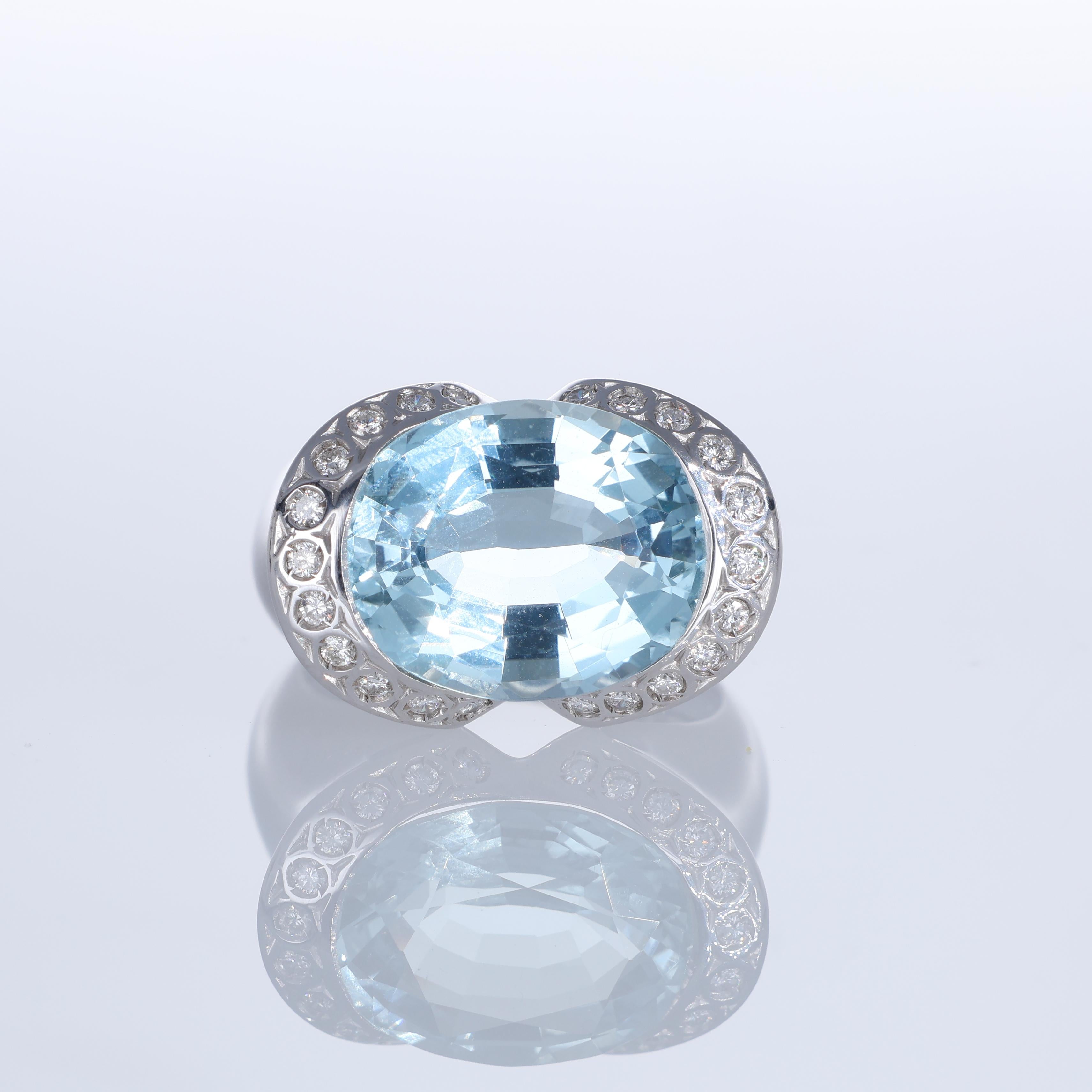 A refined 18K white gold ring showcasing an 8.73-carat oval aquamarine, its luminous blue hue complemented by the brilliance of natural diamonds. The rounded design enhances the stone’s presence, while 0.28 carats of diamonds frame the centerpiece,
