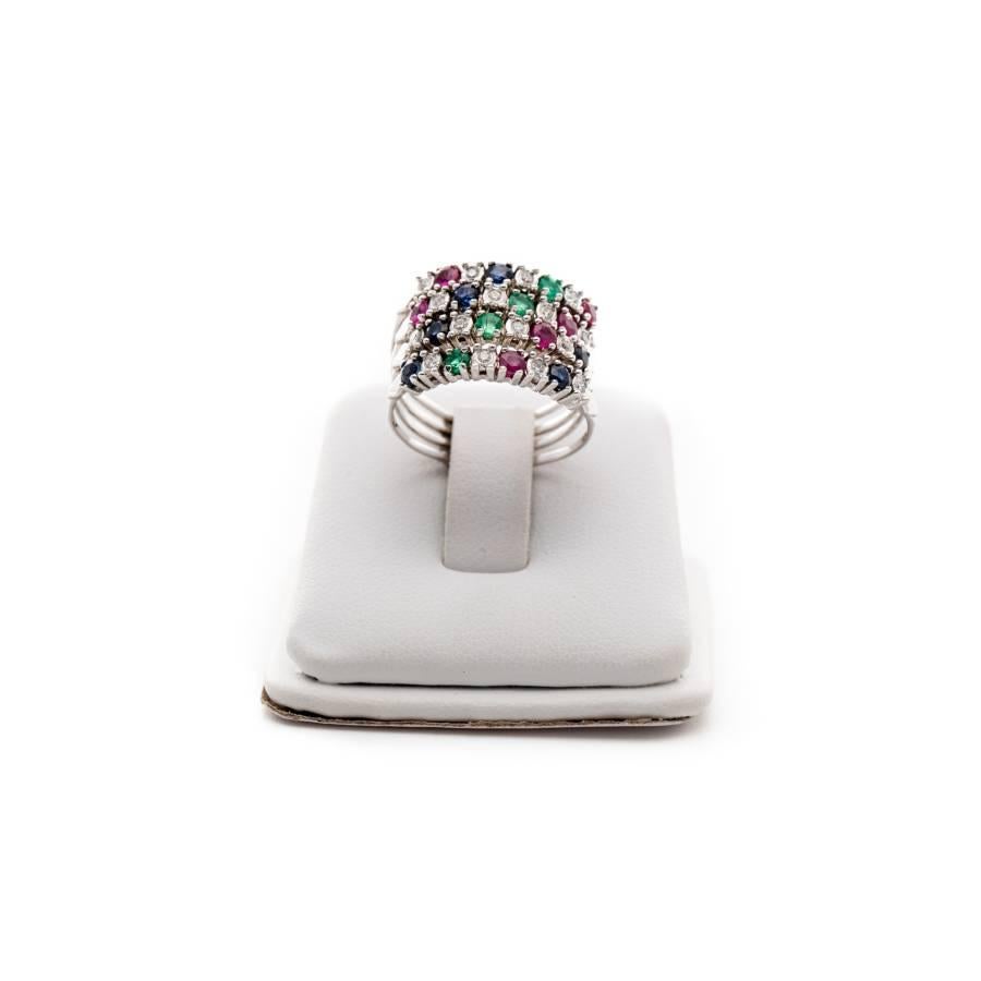 Ring made of 18K white gold, inlaid with 16 diamonds having 0.16ct, 6 sapphires having 0.30ct, 4 emeralds having 0.20ct and 6 rubbies with a total of 0.30ct. Size: 53-54. 

Precious stones, often referred to as 