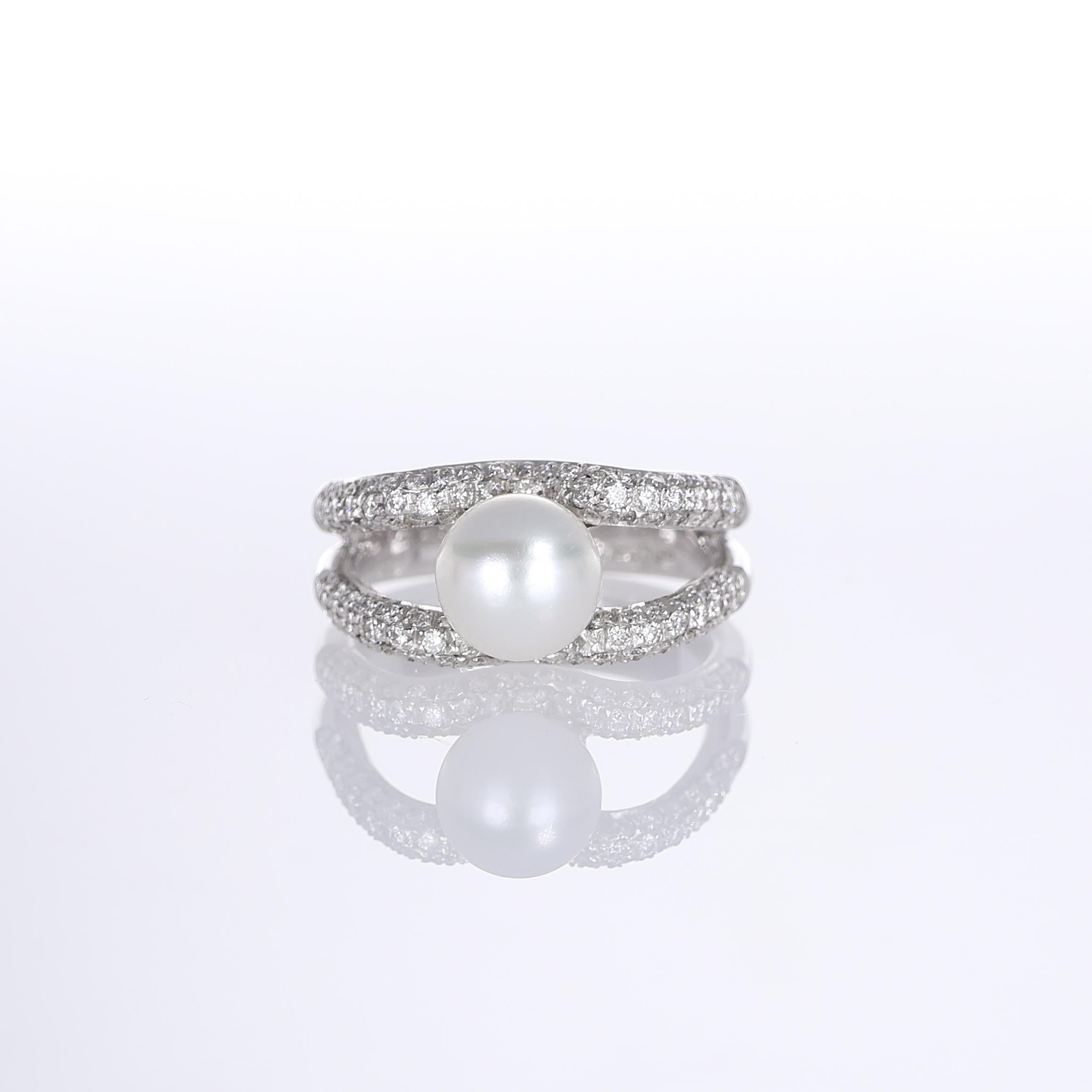 A refined 18k white gold ring featuring a lustrous central pearl framed by two rows of pavé-set natural white diamonds. The openwork design enhances the brilliance of the diamonds while maintaining a balanced elegance. This sophisticated piece