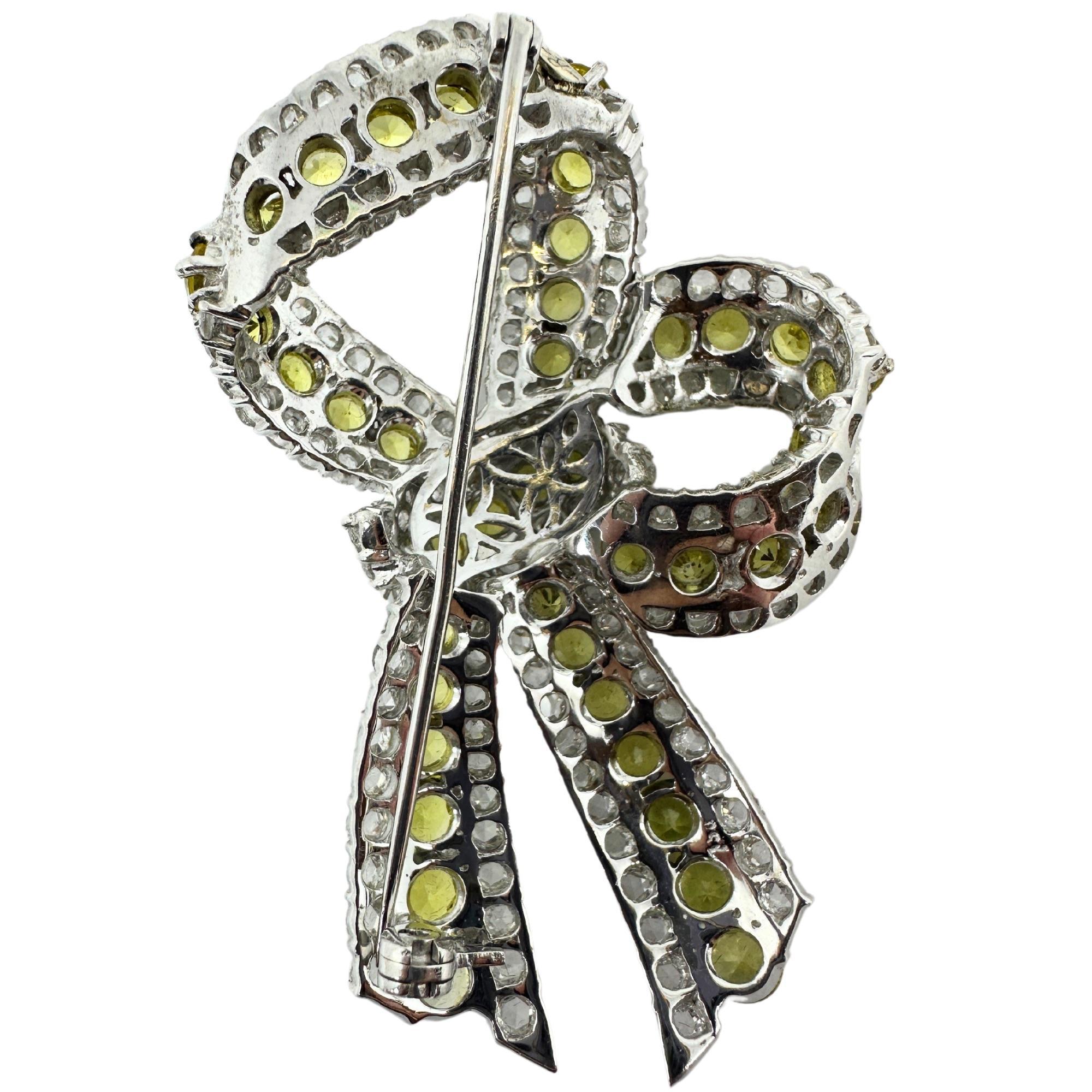 18K White Gold Rose Cut Diamond and Yellow Sapphire Bow Brooch
Condition: In good condition with some minor surface wear consistent with age.
Length: 2.5 inches 
Width: 1.5 inches
Metal: 18k White Gold
Weight: 26.5 grams
Yellow Sapphire: 11.99