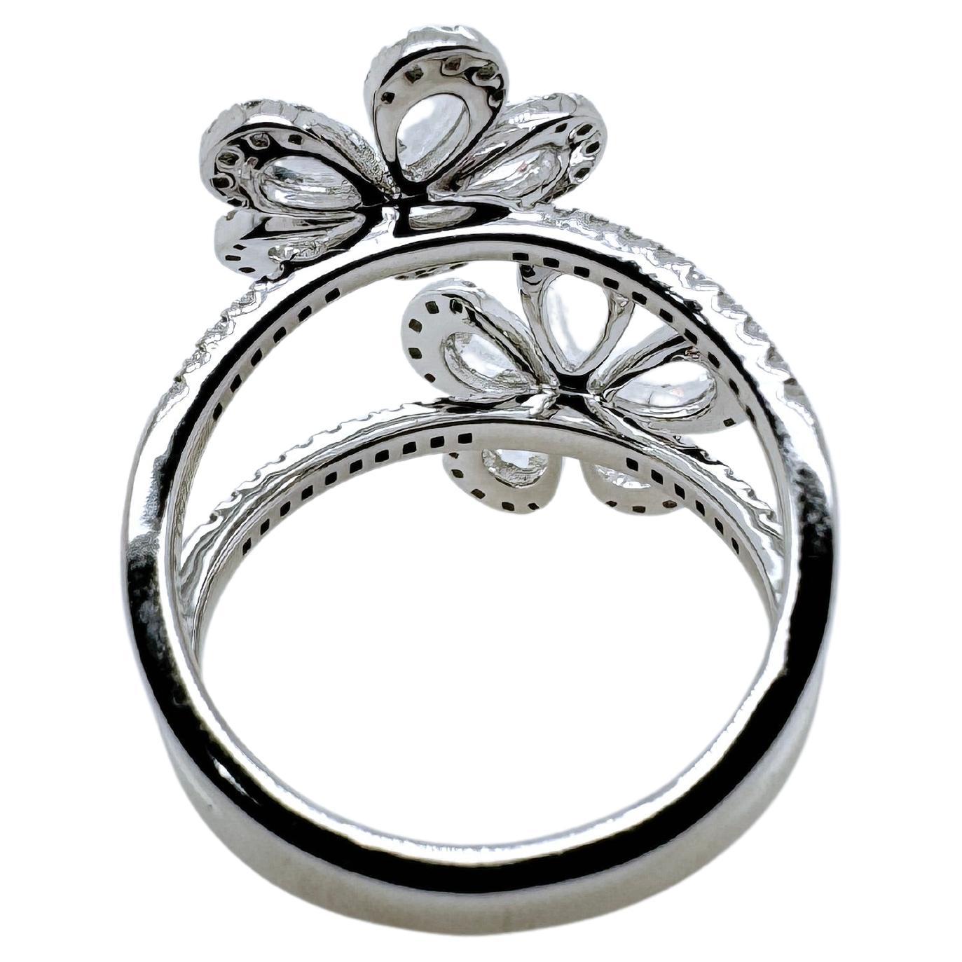 This spectacular diamond ring as pear shaped, rose cut diamonds with round brilliant diamonds st in 18k white gold.  The brilliance and sparkle of the rose cut diamonds truly is eye captivating and will grasp everyone's attention. The double flower