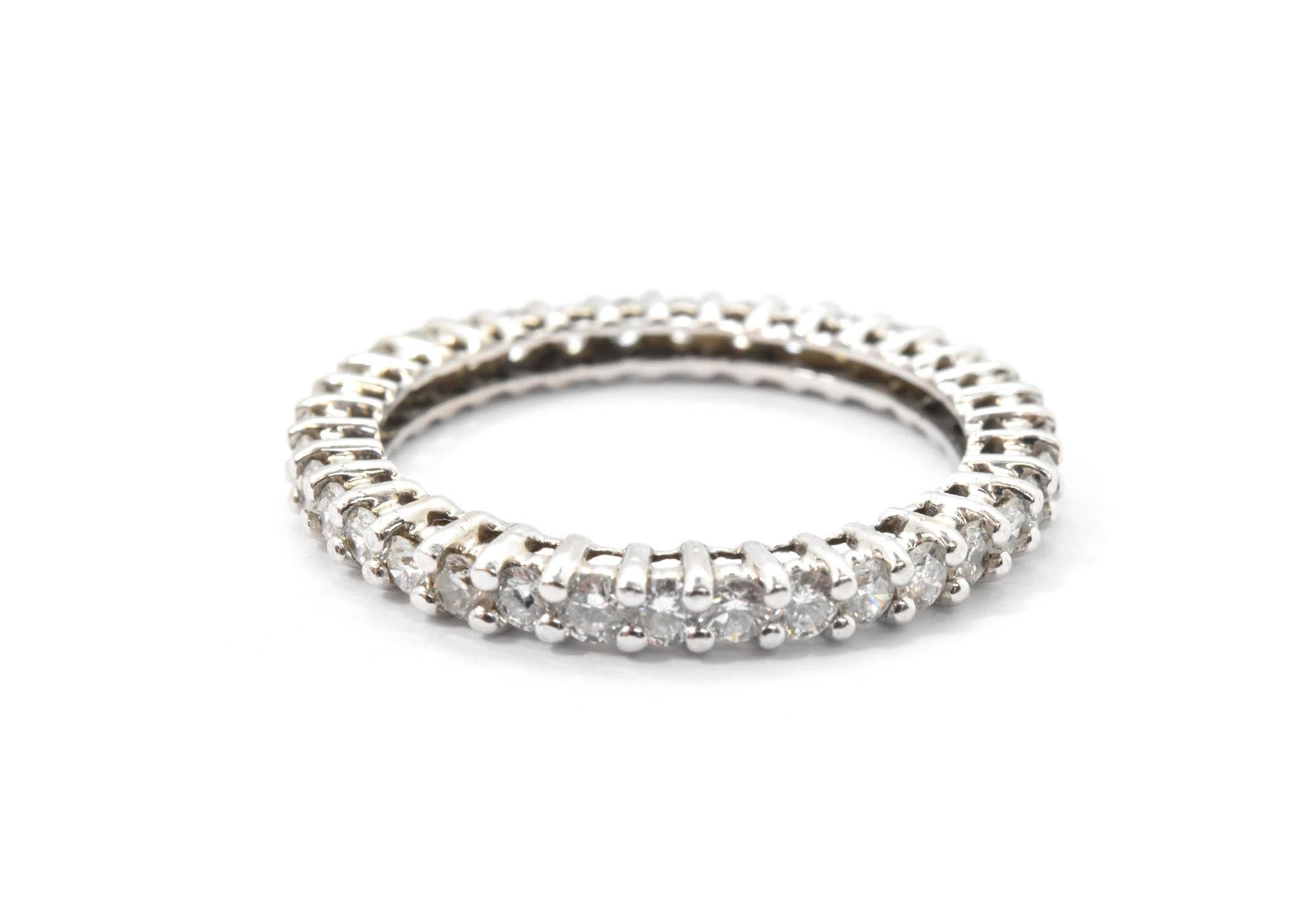 This diamond band has 36 round cut diamonds prong set in 18k white gold eternity style band. The 36 round diamonds combined weigh 0.75 carats, and are graded G in color and VS-SI in clarity. The mounting of this ring is beautifully made with white