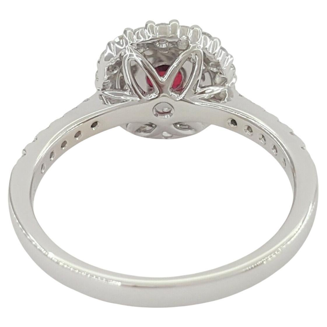 Capture the essence of timeless elegance with this stunning 18k White Gold Double Halo Ring, designed to mesmerize with its exquisite craftsmanship and captivating gemstones. At its heart lies a brilliant Natural Red Ruby, boasting a weight of 0.48