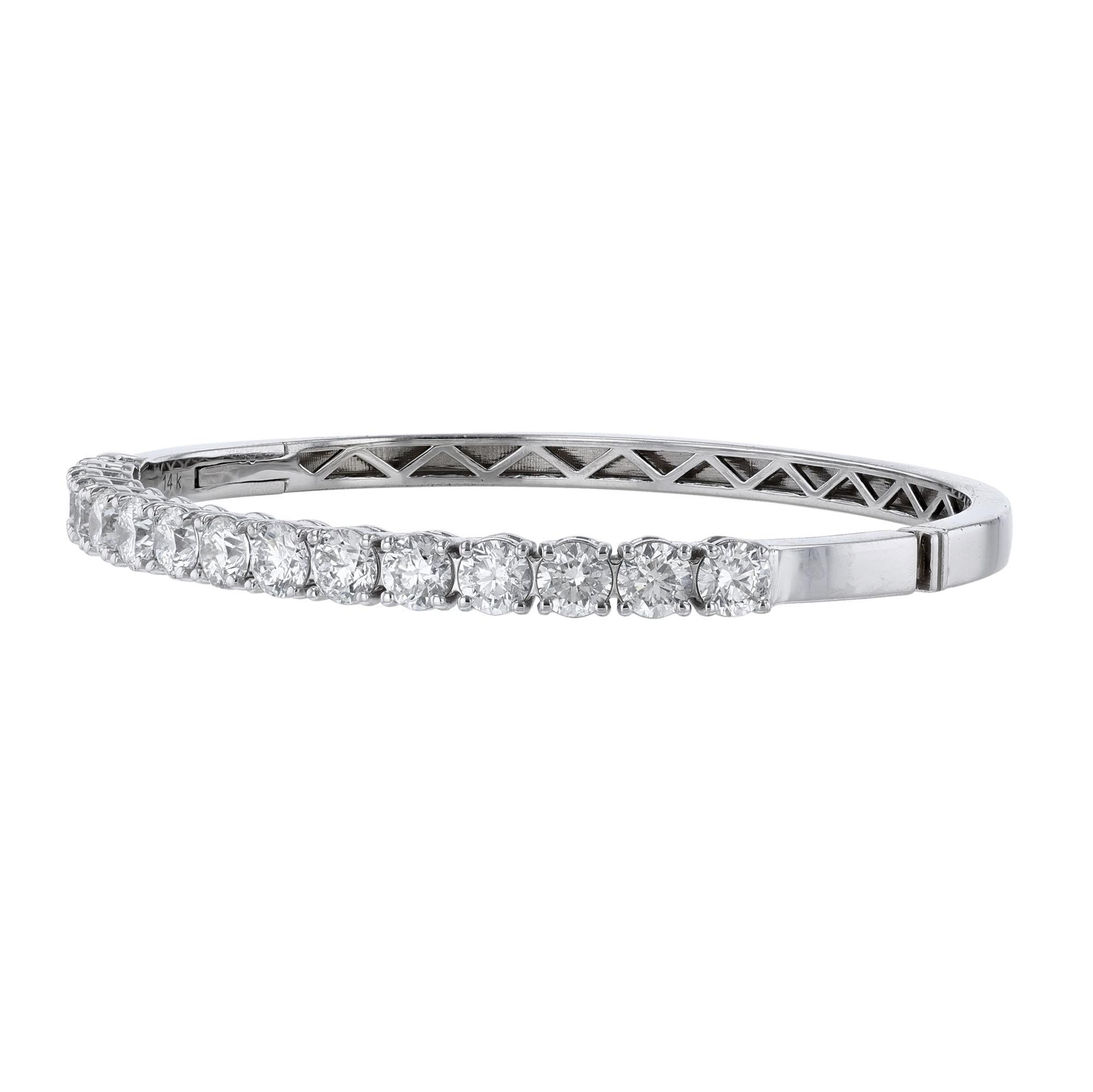 This bangle is made in 14K white gold and features 15 round cut diamonds weighing 4.67 carats. This bangle has a color grade (H) and clarity grades of I1 and SI2.
