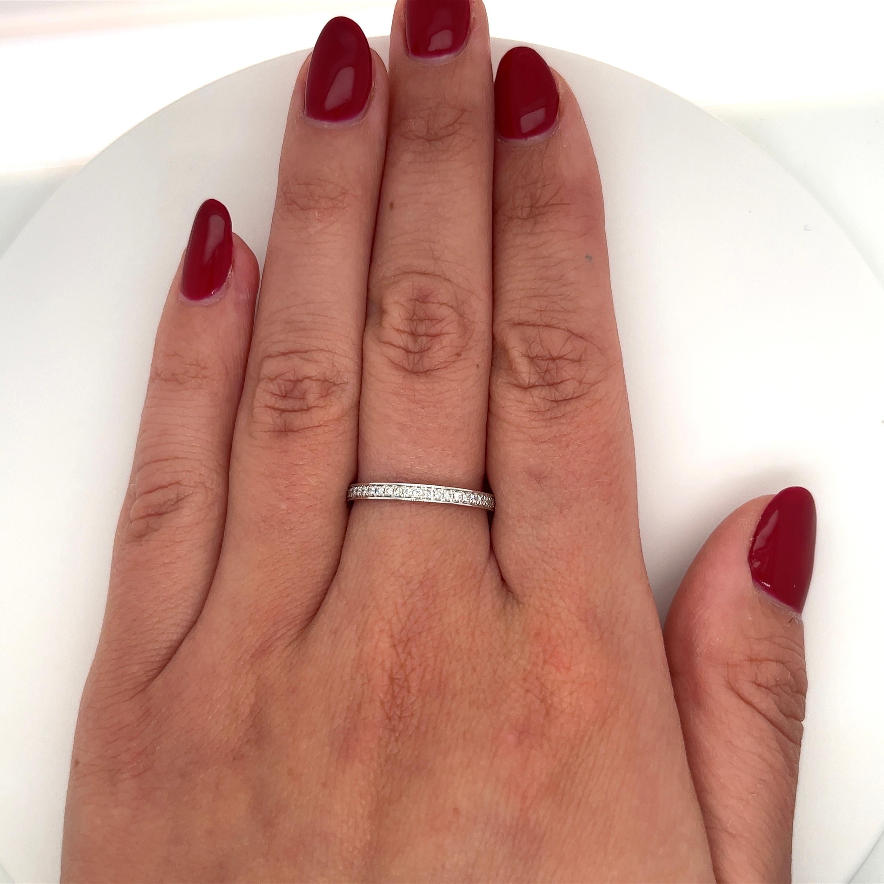 Simple, chic, and full of grace. This natural diamond wedding eternity band is set in smooth 18k white gold that glides on the finger like butter. Double rhodium plated for optimal brilliance and sparkle. 

Certificate of appraisal included upon