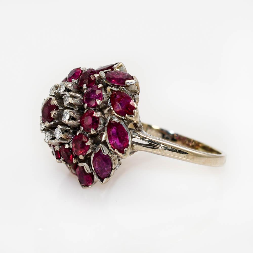 There is 3.50tcw of natural rubies and diamonds. 
Stamped 18k, weighs 8.8gr
Size 8 1/4