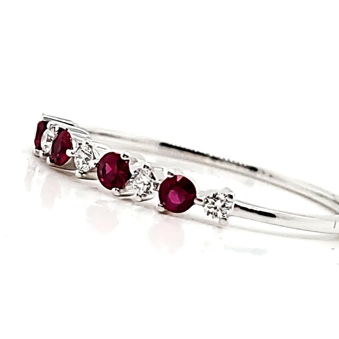 Fiery rubies and dazzling diamonds intertwine to ignite the passion within your soul. 

Adorned with four round rubies from Myanmar totaling 0.17 carats and five round diamonds totaling 0.09 carats.

All set alternately in lustrous 18K white gold,
