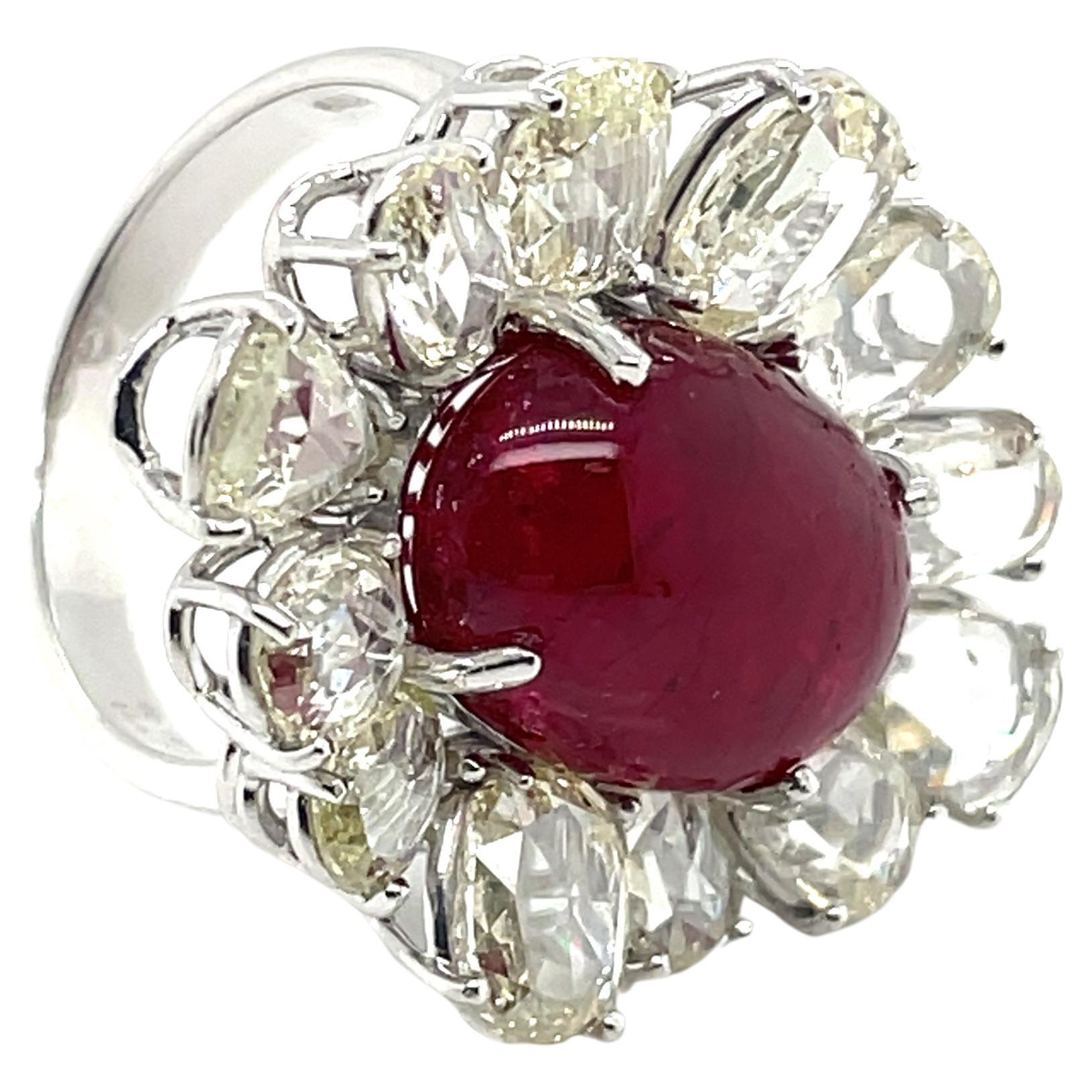 At the center of this breathtaking engagement ring lies a mesmerizing 10.61 ct Ruby Cabochon, a gem revered for its deep red hue.

Sourced from Burma, this ruby is flanked by 12 rose-cut diamonds (4.73 cts) that shimmer with an ethereal glow, all