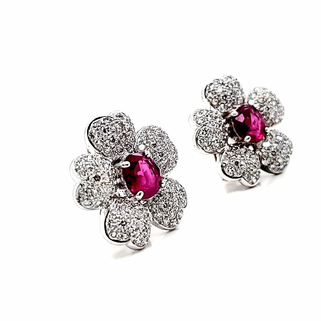 Adorned with 2 oval rubies totaling 4.15 carats, these tassel earrings are surrounded by delicate diamond petals, creating a mesmerizing floral motif. 

Cascading from these petals are luscious ruby beads totaling a remarkable 166.92 carats,