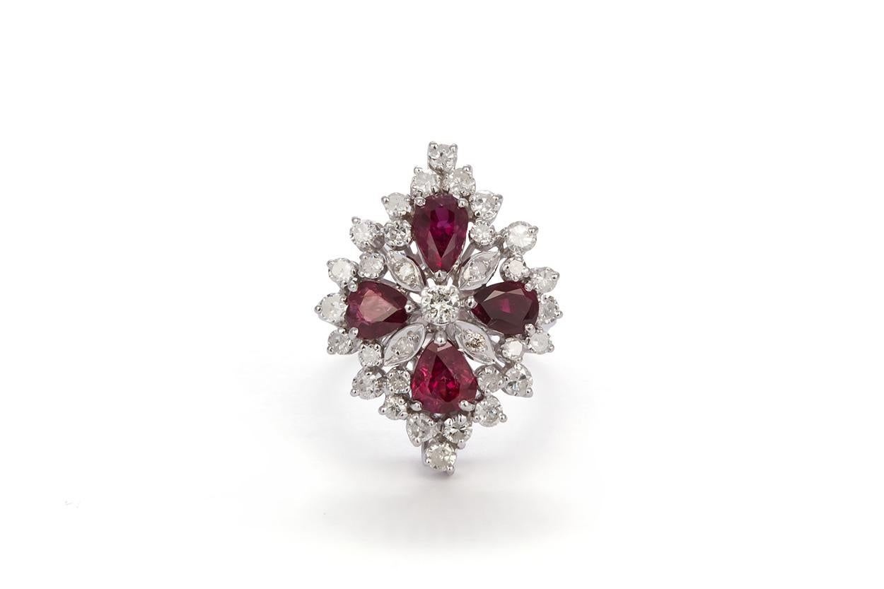 We are pleased to offer this 18k White Gold Ruby & Diamond Cocktail Ring. This stunning ring feature an estimated 2.25ctw natural rubies accented by an estimated 1.60ctw H-I/SI1-SI2 round cut diamonds all set in a 18k white gold mounting. The ring