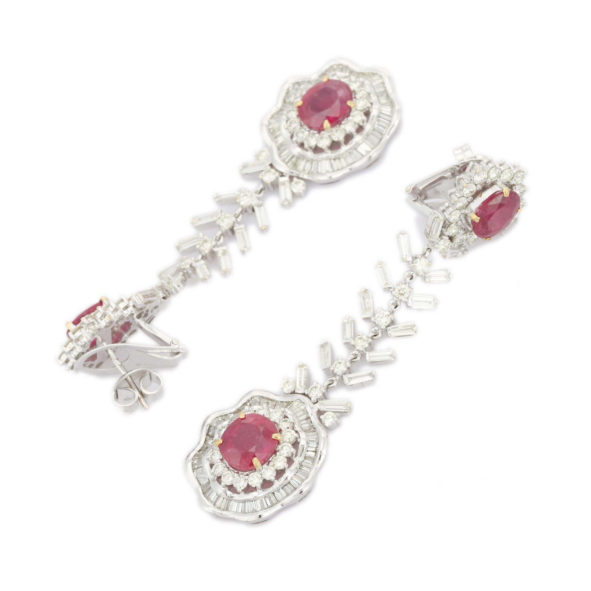 Floral Diamond Ruby Dangle Drop Earrings in 18K Gold to make a statement with your look. You shall need statement dangle earrings to make a statement with your look. These earrings create a sparkling, luxurious look featuring oval cut rubies.
Ruby
