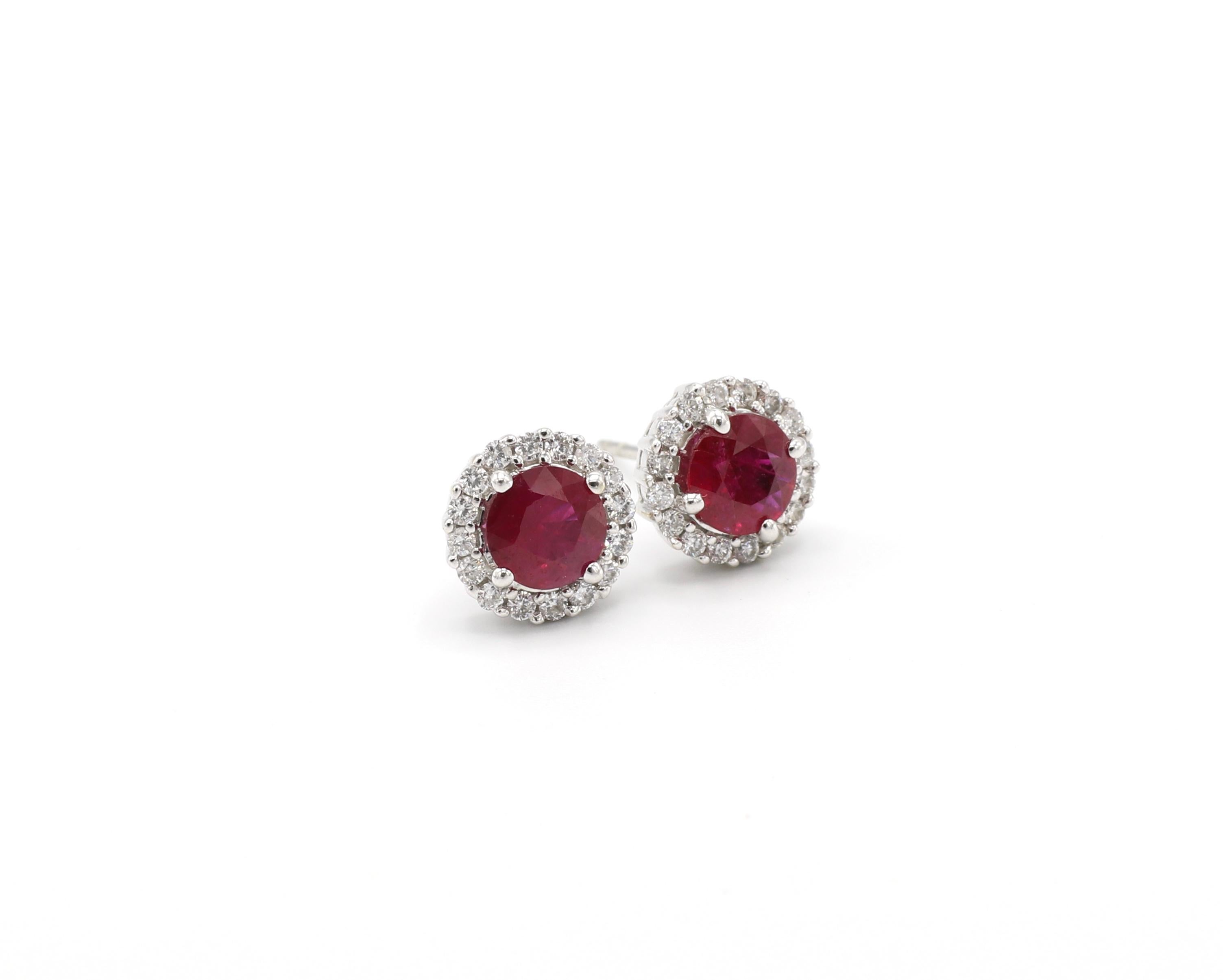 18k White Gold Ruby Diamond Halo Stud Earrings Round Brilliant Cut

Metal: 18K White Gold
Weight: 4.35 grams
Diamonds: 32 round brilliant cut diamonds measuring approx. 0.40 ctw G-H SI
Rubies: 2 round red rubies, approx. 2.30 CTW
Earrings measure