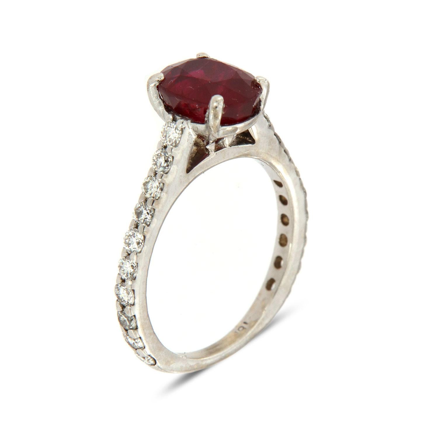 This Pre Owned 18k White Gold ring features twenty brilliant round diamonds Micro-Prong set on a 2.1 MM wide band. In the center of the ring is set 2.68 Carat Oval Shaped Ruby GIA certificate number 5201148744. The ruby showcases a pretty deep red