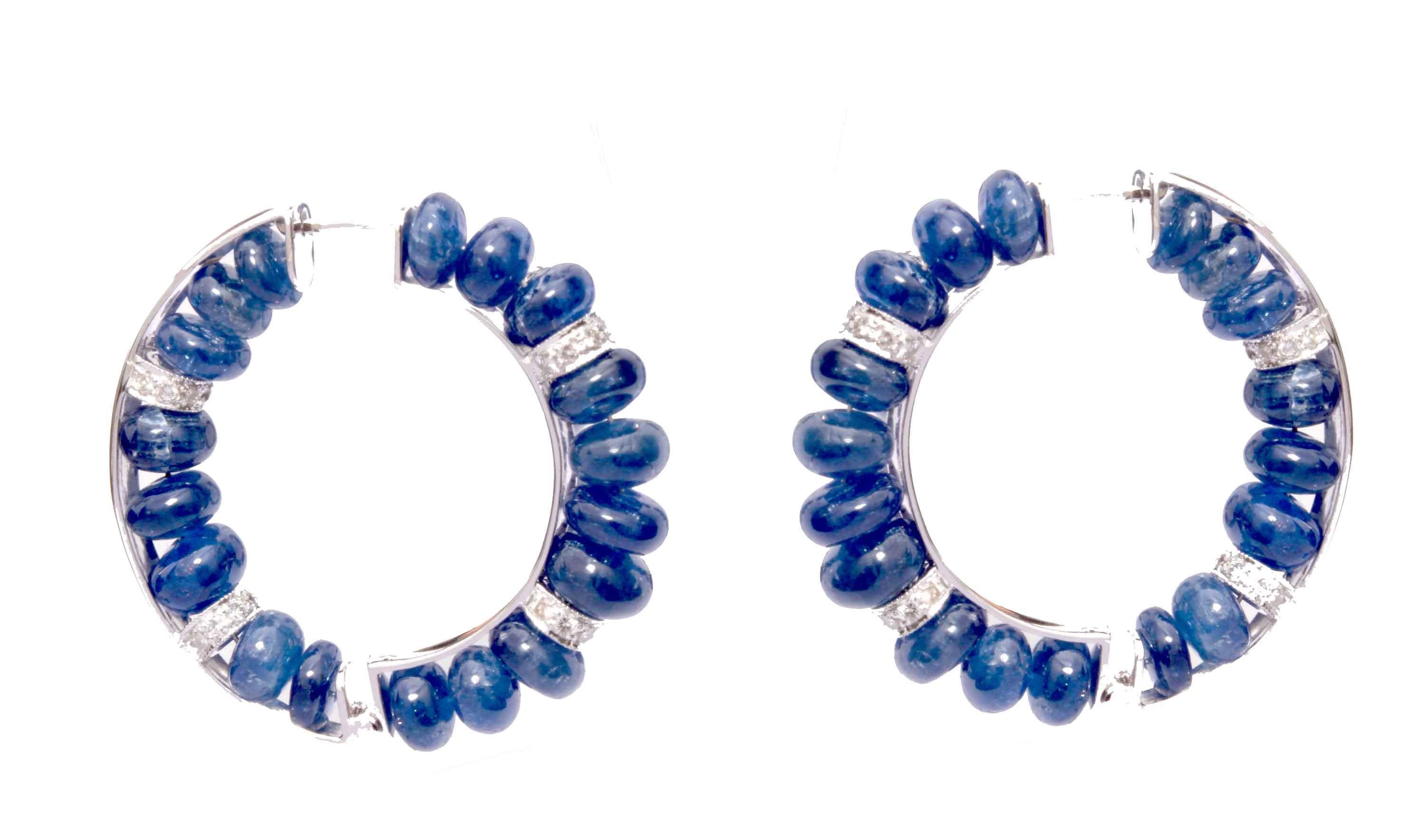 A very beautiful sapphire hoop earrings is easy to wear many occasions and day time and party time. This pair of hoops embellished with 36 pieces of blue sapphires weighing 64.06 carats, with 56 pieces of round cut white diamonds weighing 0.95