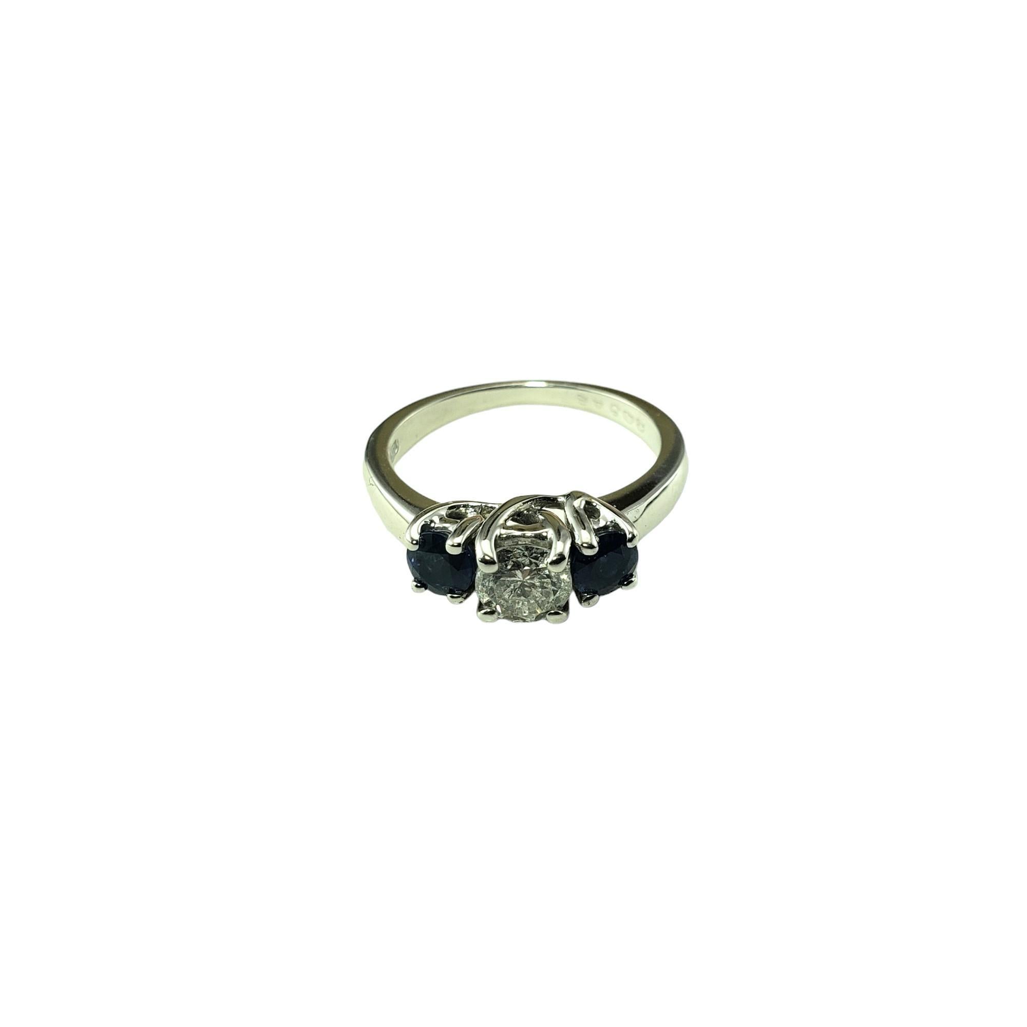 Vintage 18 Karat White Gold Sapphire and Diamond Ring Size 6 JAGi Certified #15731-

This elegant ring features one round brilliant cut diamond and two natural blue sapphires set in classic 18K white gold.  Width:  5 mm.  Shank: 1.7 mm.

Total