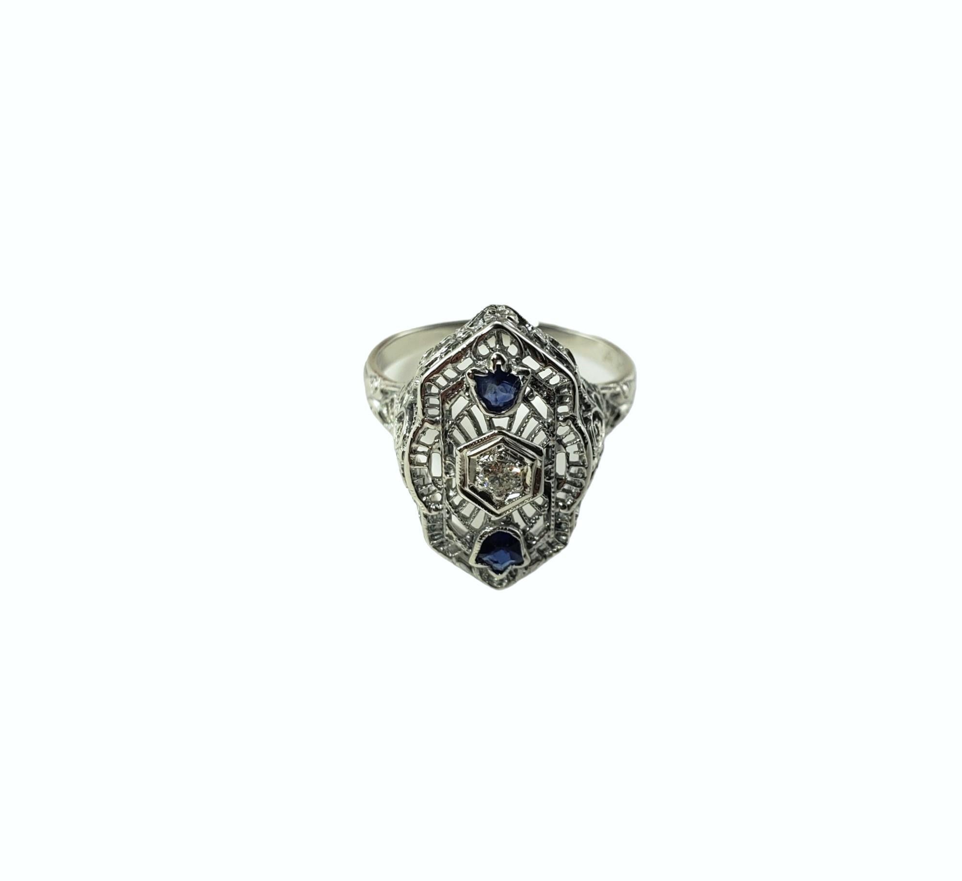Vintage 18K White Gold Sapphire and Diamond Ring Size 6.75-

This elegant ring features one round brilliant cut diamond and two fancy cut blue sapphires set in beautifully detailed 18K white gold filigree.  Top of ring measures 
18.7 mm x 13.1 mm. 