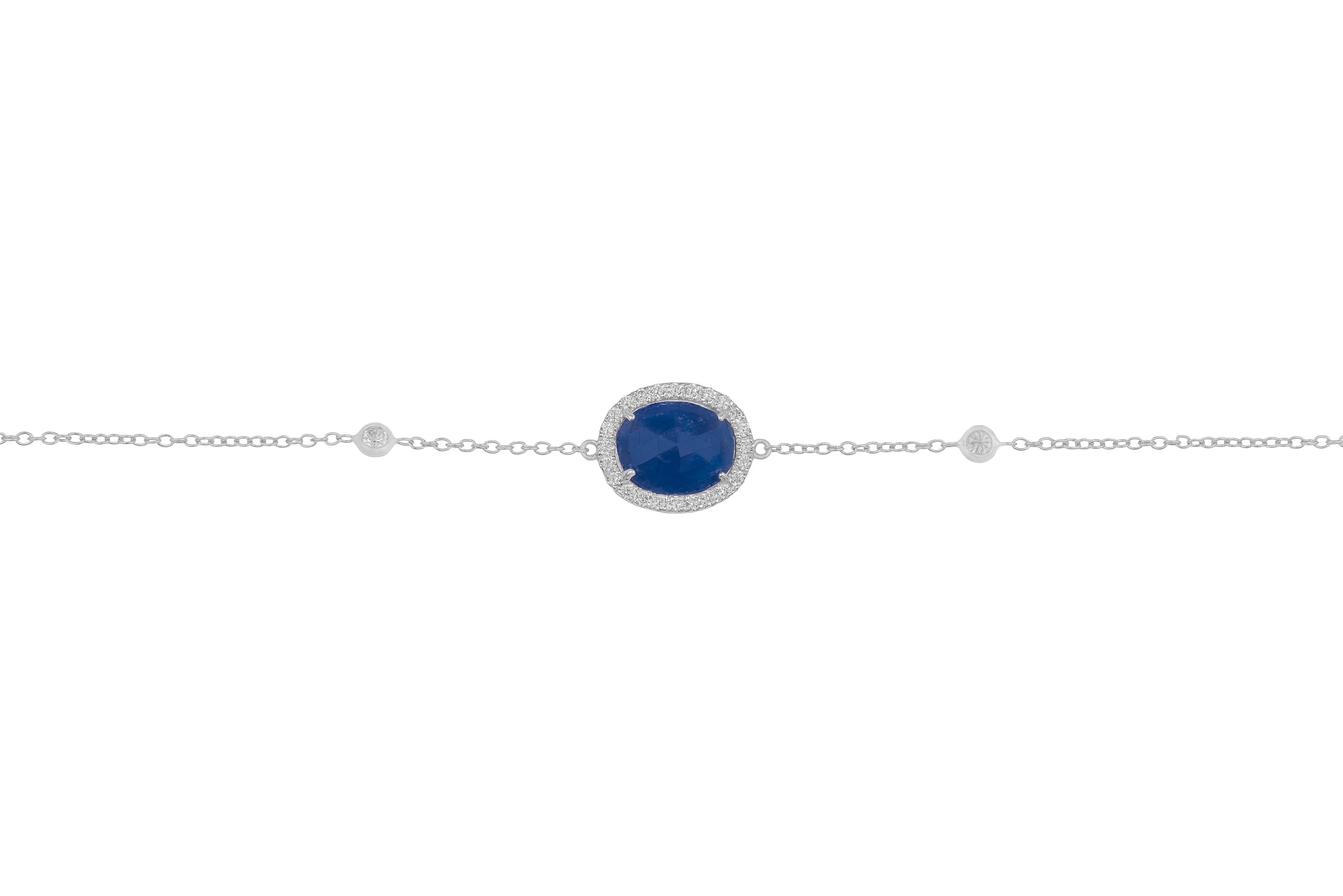 This 18k white gold bracelet with sapphire and white diamonds is made in Italy by Fanuele Gioielli.    
It features an oval cut sapphire surrounded by a row of brilliant cut white diamonds placed at the centre, plus two brilliant cut diamonds in a