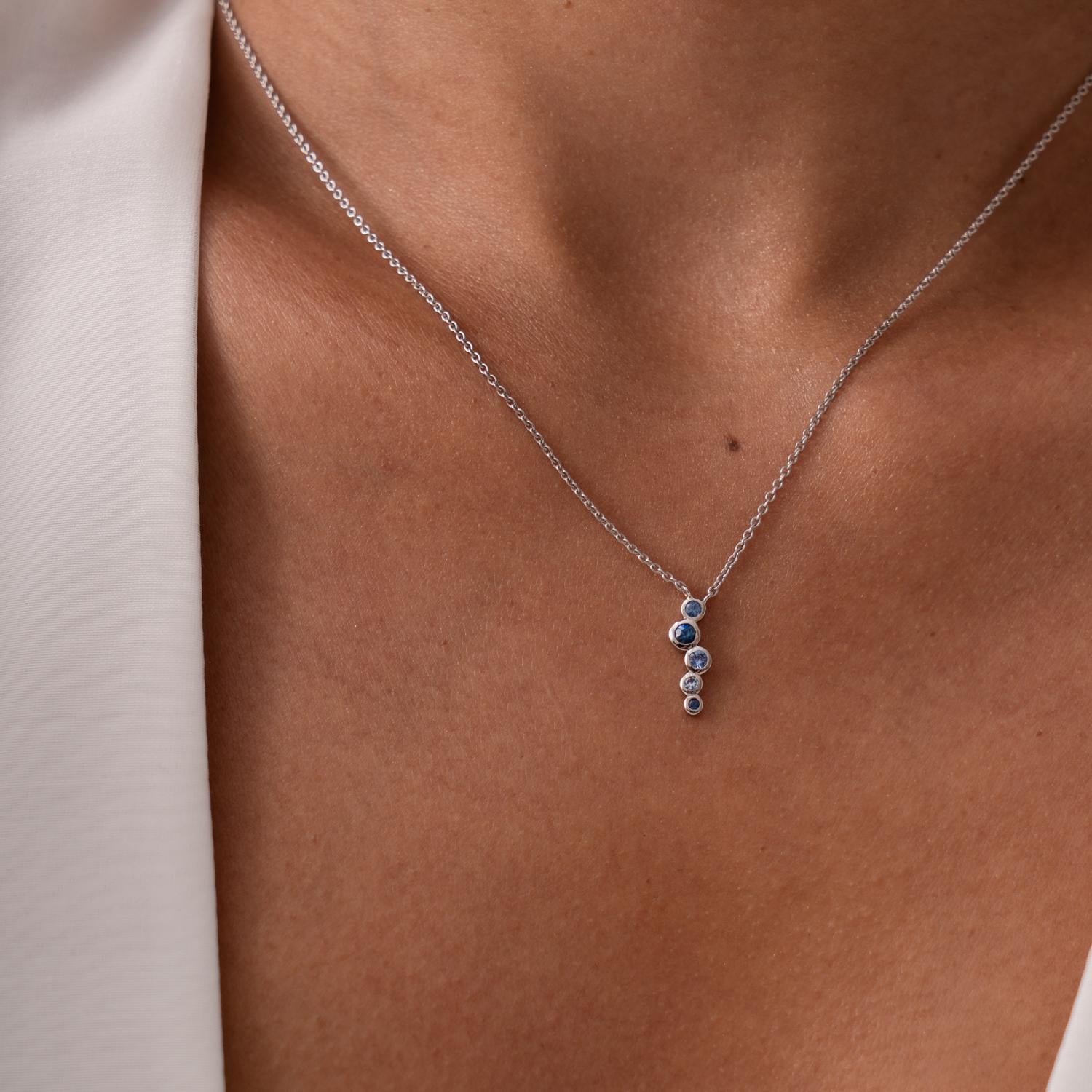 Luxuriously handcrafted in 18ct white gold, this elegant Cascade pendant features a delicate waterfall of 5 blue sapphires and aquamarines. The colourful gemstones are encased in rub-over settings in an ombre combination and suspended from fine 18ct