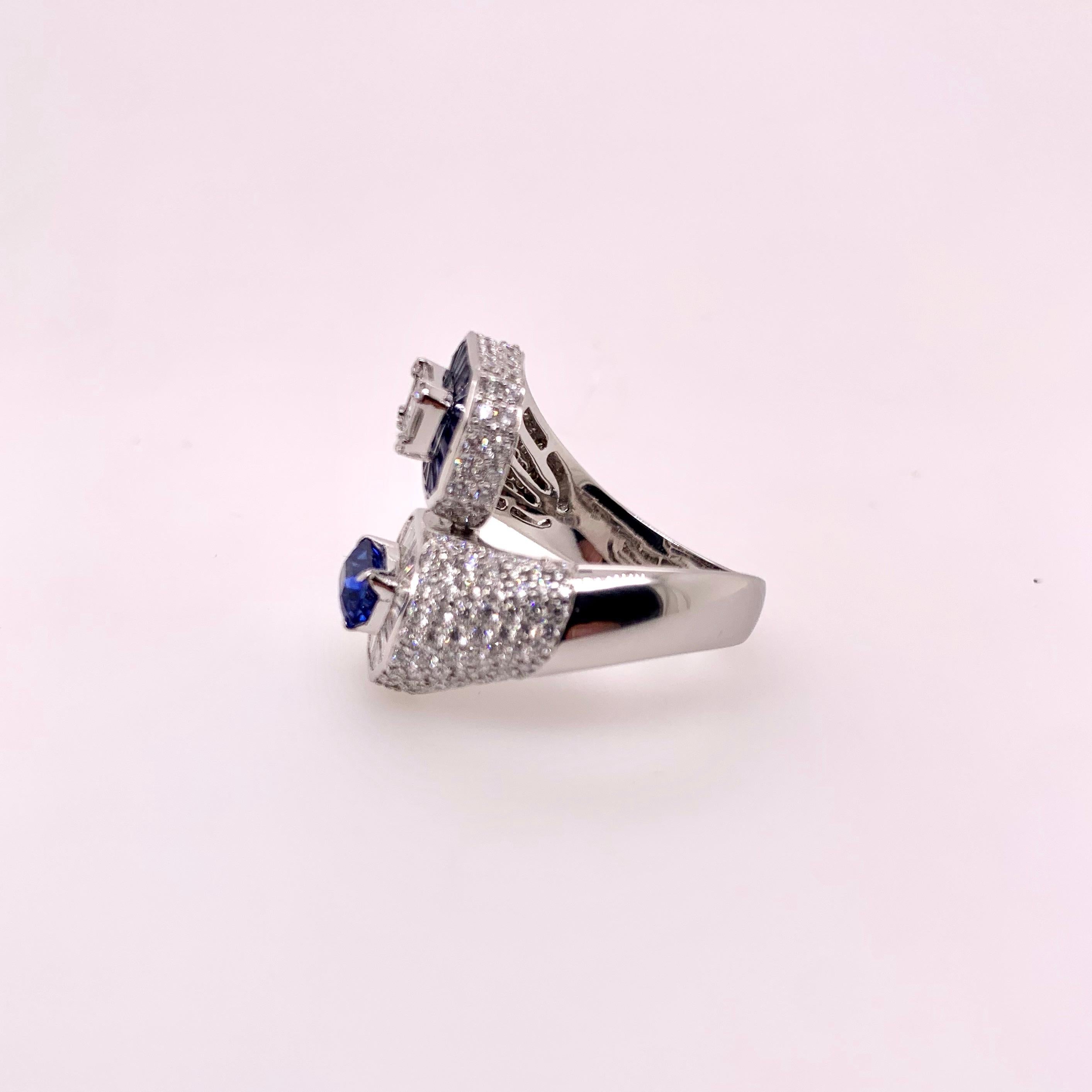 A classic combination of sapphires and diamonds in an unusual bypass style ring!  The alternating pattern gives a gorgeous contrast of the rich blue hue in the sapphires against the white diamonds in this stunning ring! 

Sapphires:  1.22 cts,