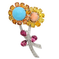 Broche fleur en or blanc 18 carats, saphirs, diamants et citrine