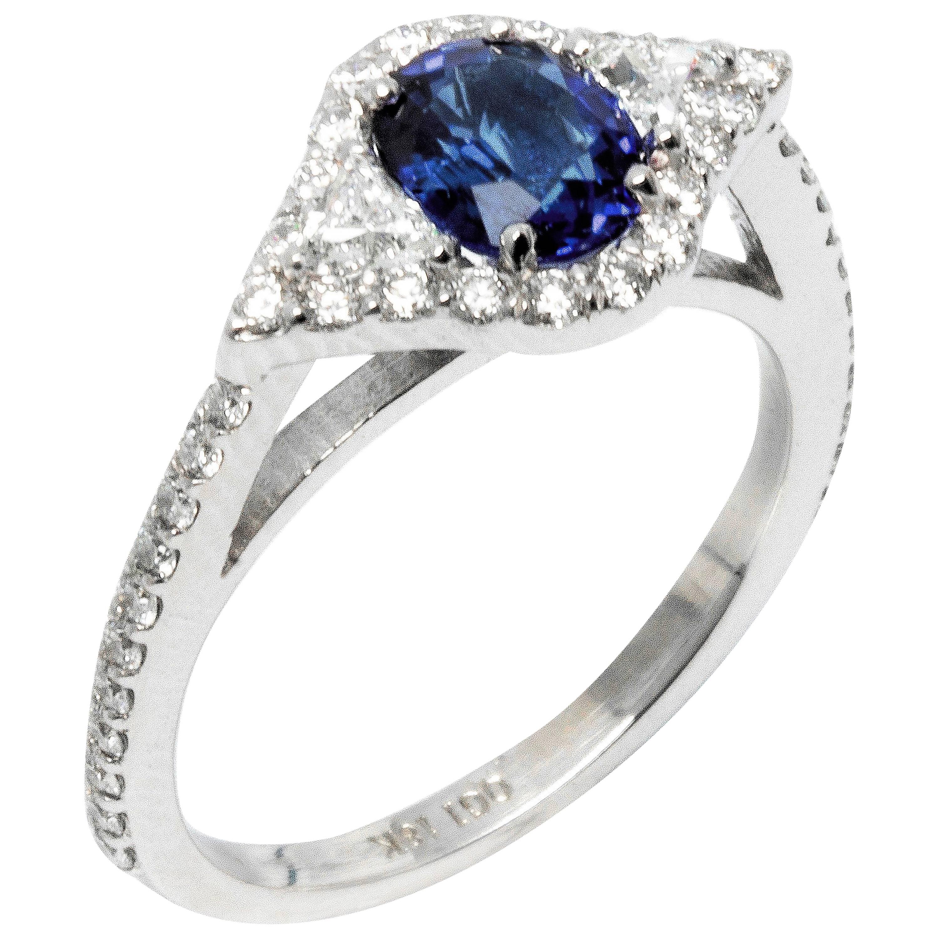 Featuring 18k white gold engagement ring with one carat sapphire and surrounded with melee diamonds. 
Sapphire Weight 1.00 carat
Trillion diamonds weighing 0.25 carats 
Round diamond weighing 0.70 carats.
Diamond quality G VS
New ring 
Ring can be