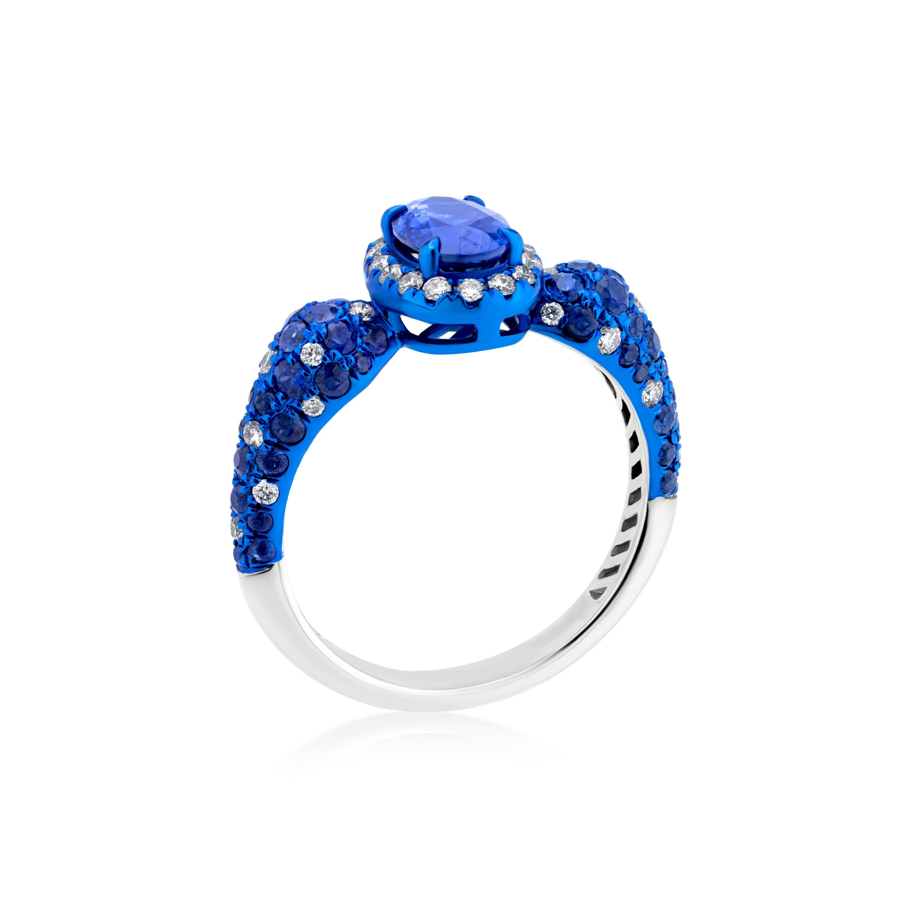 Indulge in the captivating allure of this exquisite sapphire and diamond halo ring. Crafted in polished 18K white gold, this ring showcases a vibrant oval-cut blue sapphire as its centerpiece.

The sapphire, weighing approximately 1.8 carats, is a