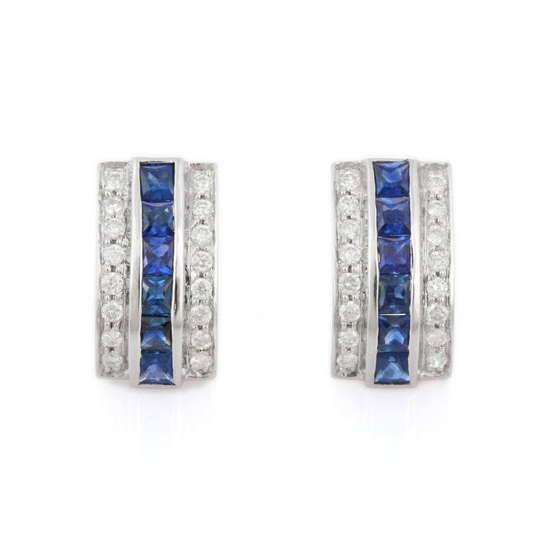 Studs create a subtle beauty while showcasing the colors of the natural precious gemstones and illuminating diamonds making a statement.

Square cut blue sapphire studs with diamonds in 18K gold. Embrace your look with these stunning pair of