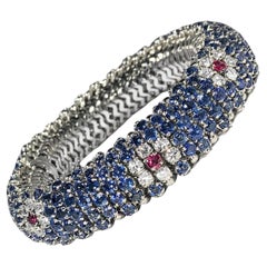 18K White Gold Sapphire Encrusted Bombe Bracelet with Diamond & Ruby Flowers