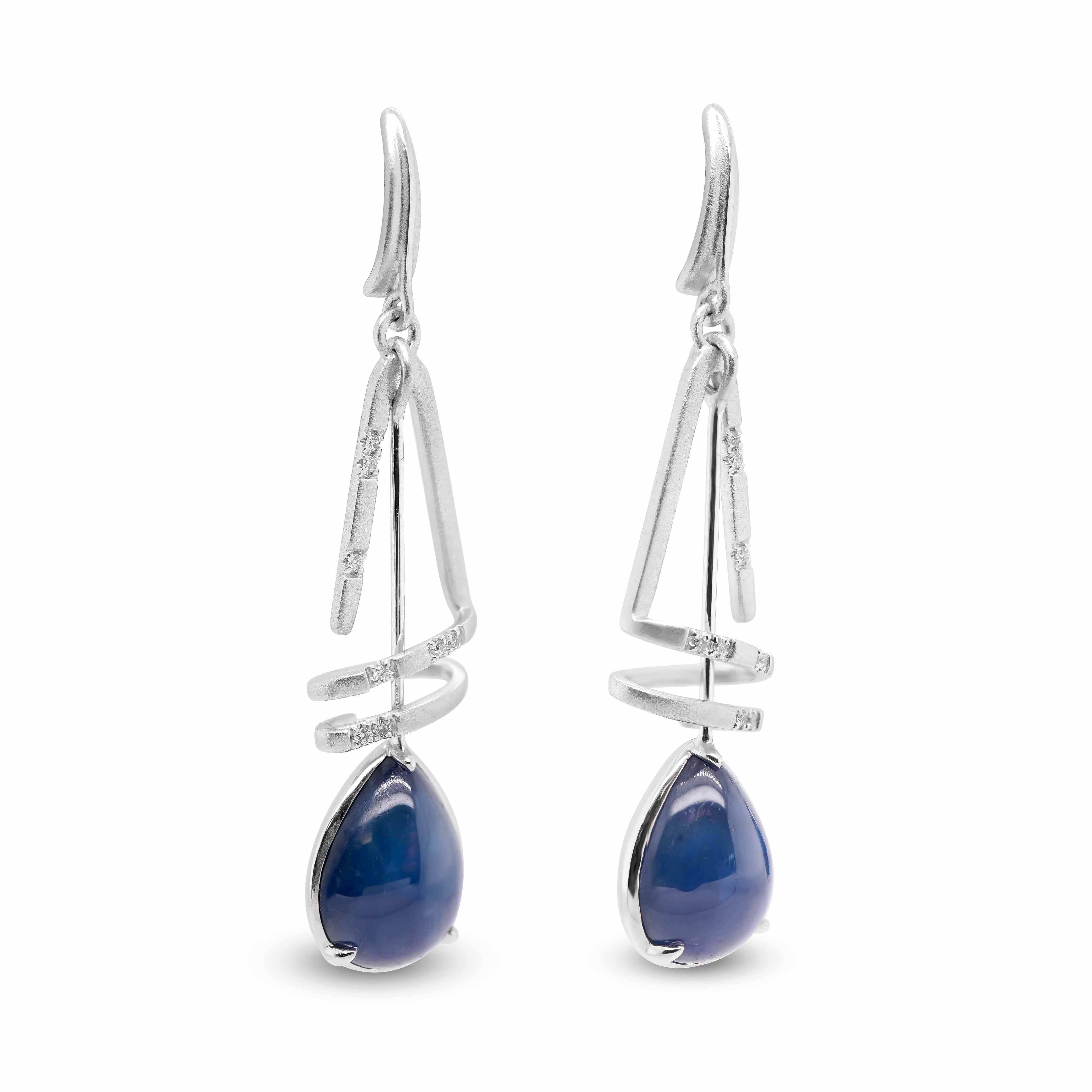  A pair of earrings, each comprising of a pear shaped sapphire weighing 6.74cts suspended by a spiral of 16 white diamonds.
Blue Sapphires are highly sought after gems today. Their stunning array of blues have captured the attention of many, over