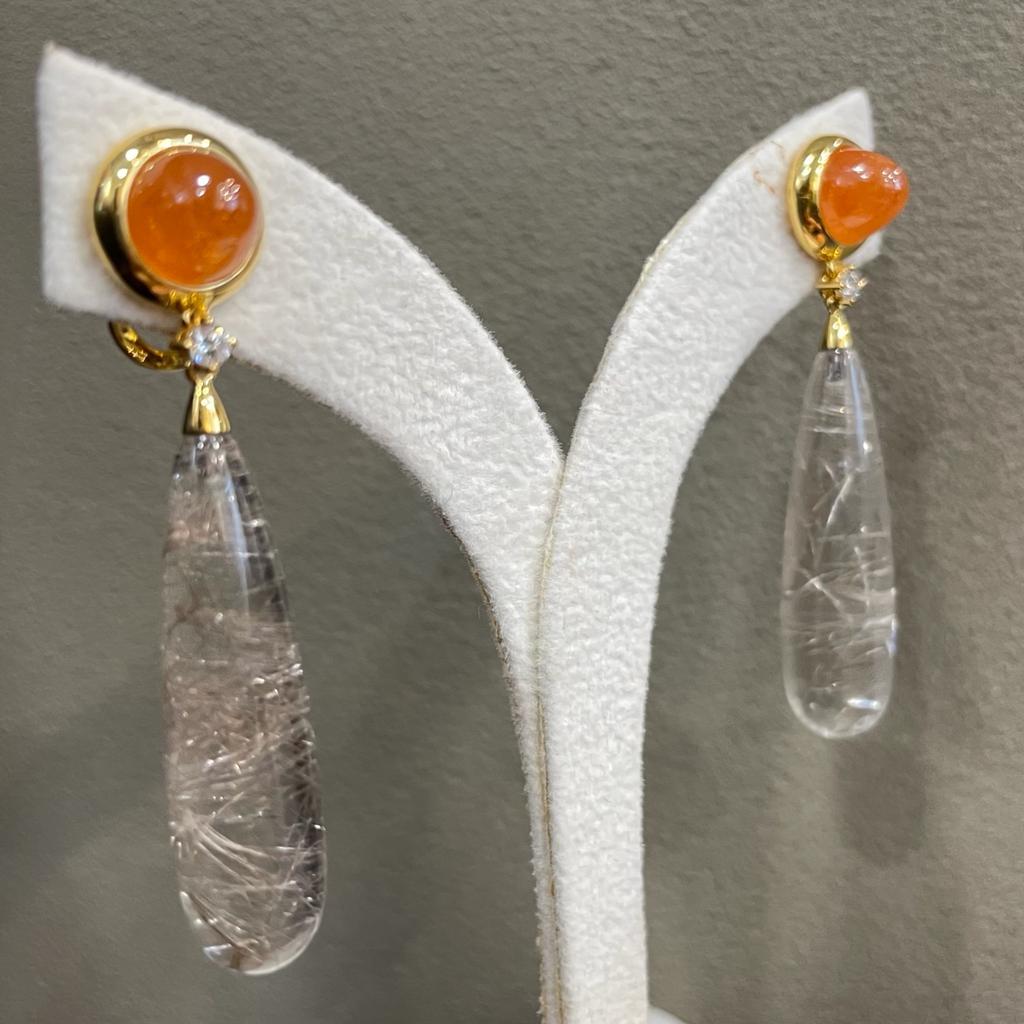 These chandelier earrings are bold and beautiful! Totaling 43.64 carts gold quartz teardrops swing from 9.63 carats dome mandarin garnet between total 2 pieces 0.128 carats sparkling brilliant cut diamonds.