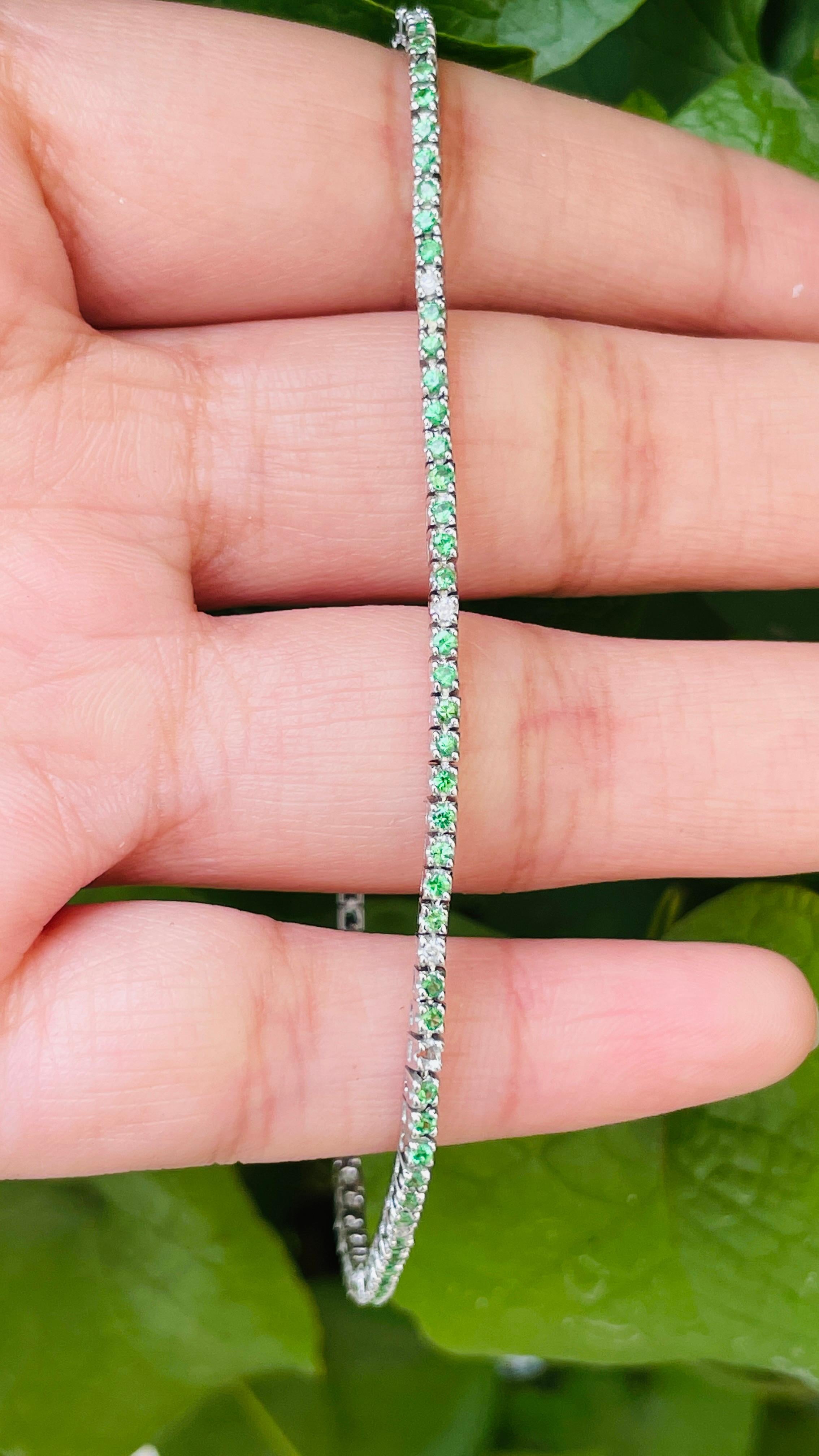 This Round-Cut Tsavorite Diamond Tennis Bracelet in 18K gold showcases 90 endlessly sparkling natural tsavorite, weighing 0.95 carats and 10 diamond pieces weighing 0.1 carat. It measures 8 inches long in length. 
Tsavorite increase the wearer's