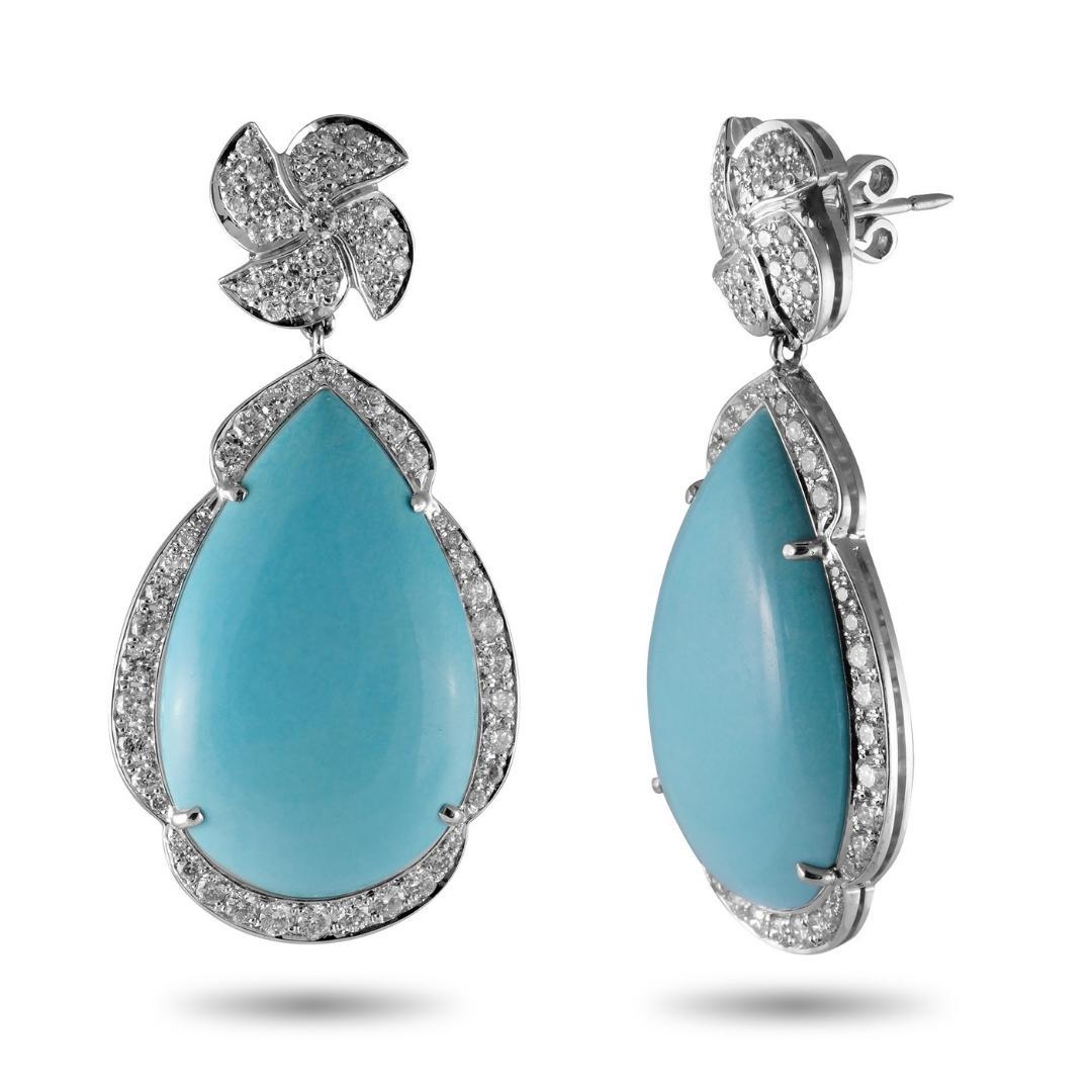 This breathtaking Sleeping Beauty Turquoise and diamond earrings are sure to be the center of attention. Set in 18k White Gold and surrounded by a 2.00 carat diamond halo, that accentuates the sky blue color of the turquoise; the absence of veins or