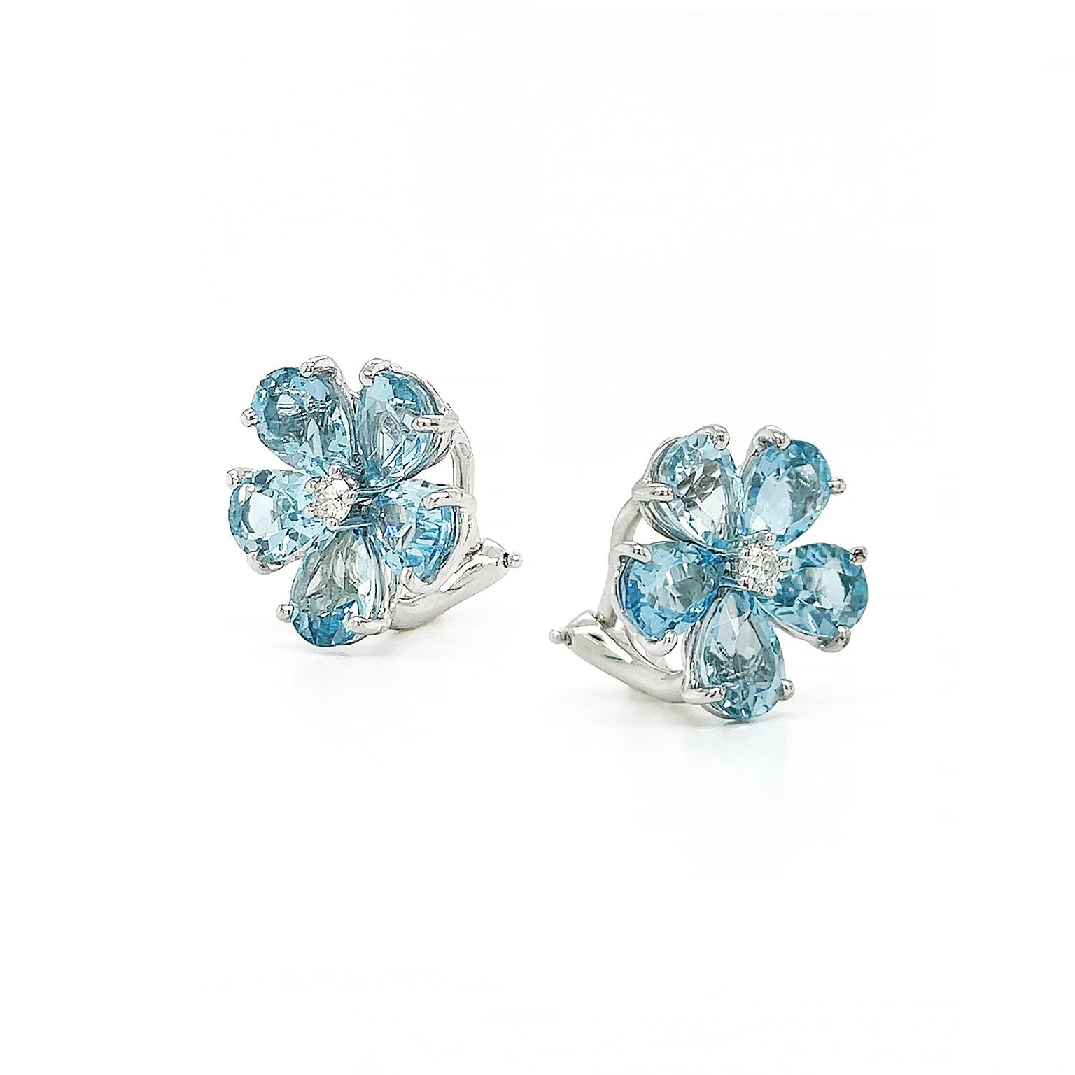 The glistening aquamarine transforms into a flower accompanied by shimmering diamonds. Pear-shaped aquamarines meet inward to form a floral motif with a single brilliant cut diamond in the center. 18k white gold both secures and accentuates each