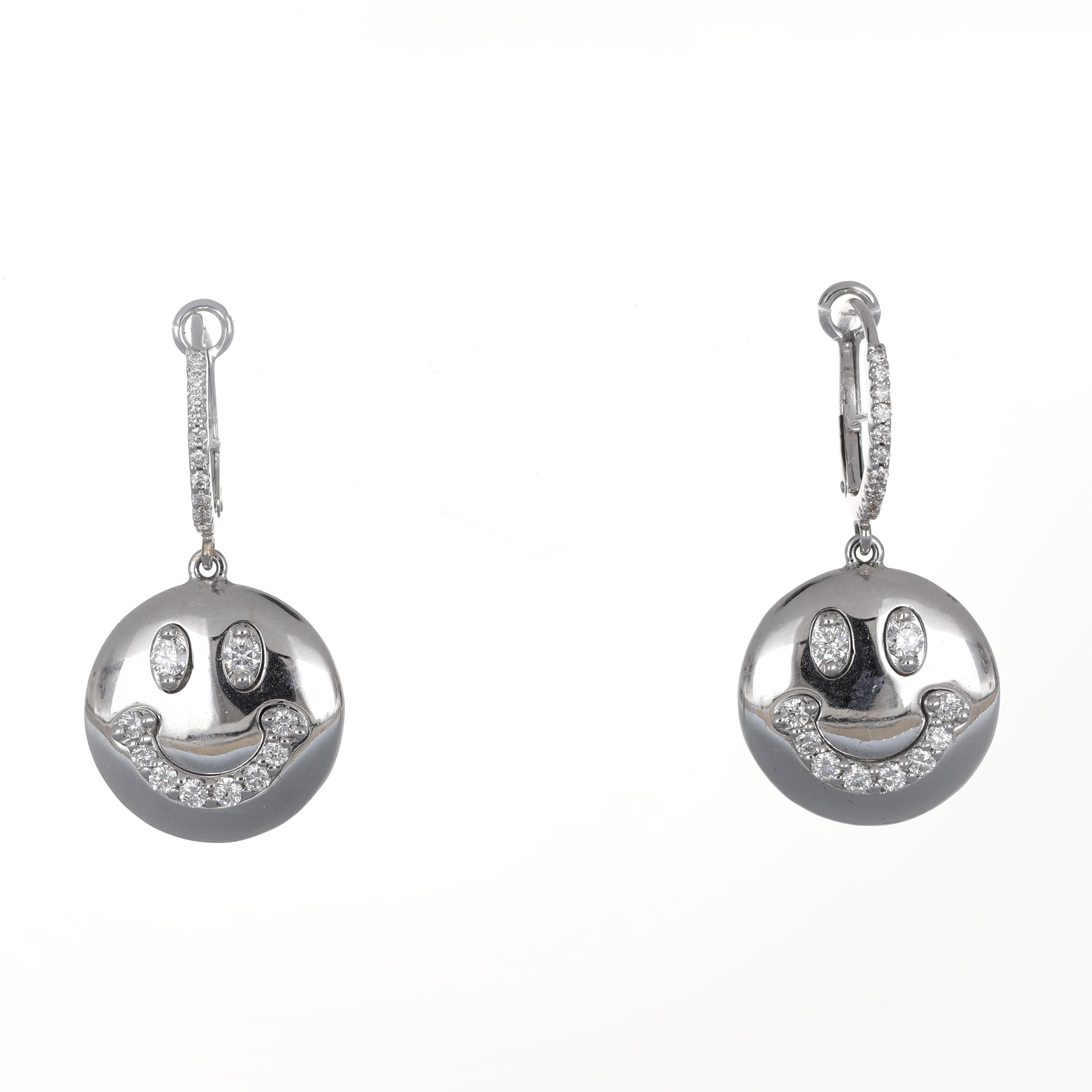 A playful yet luxurious design, these 18K white gold dangle earrings feature a polished smiley face motif, accented with brilliant-cut diamonds for a refined sparkle. The expressive eyes and curved smile are encrusted with diamonds, creating a