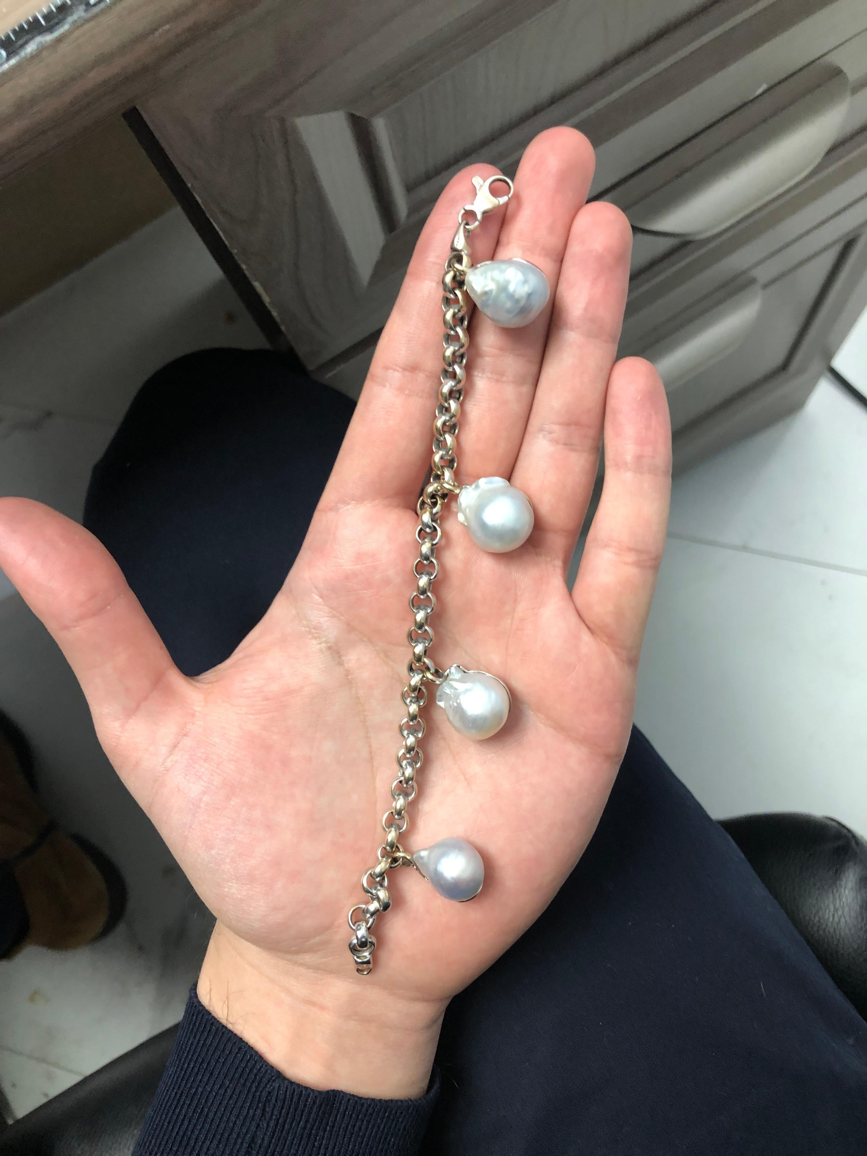 A vintage 18K white gold link bracelet consisting of 4 baroque South Sea cultured pearls measuring 16.60 x 12.90 mm - 18.38 x 15.27 mm. 
Pearl Color: White, Overtone: Rose, Luster: Good, Surface: Blemished

Stone: South Sea Cultured Pear

Metal: 18K
