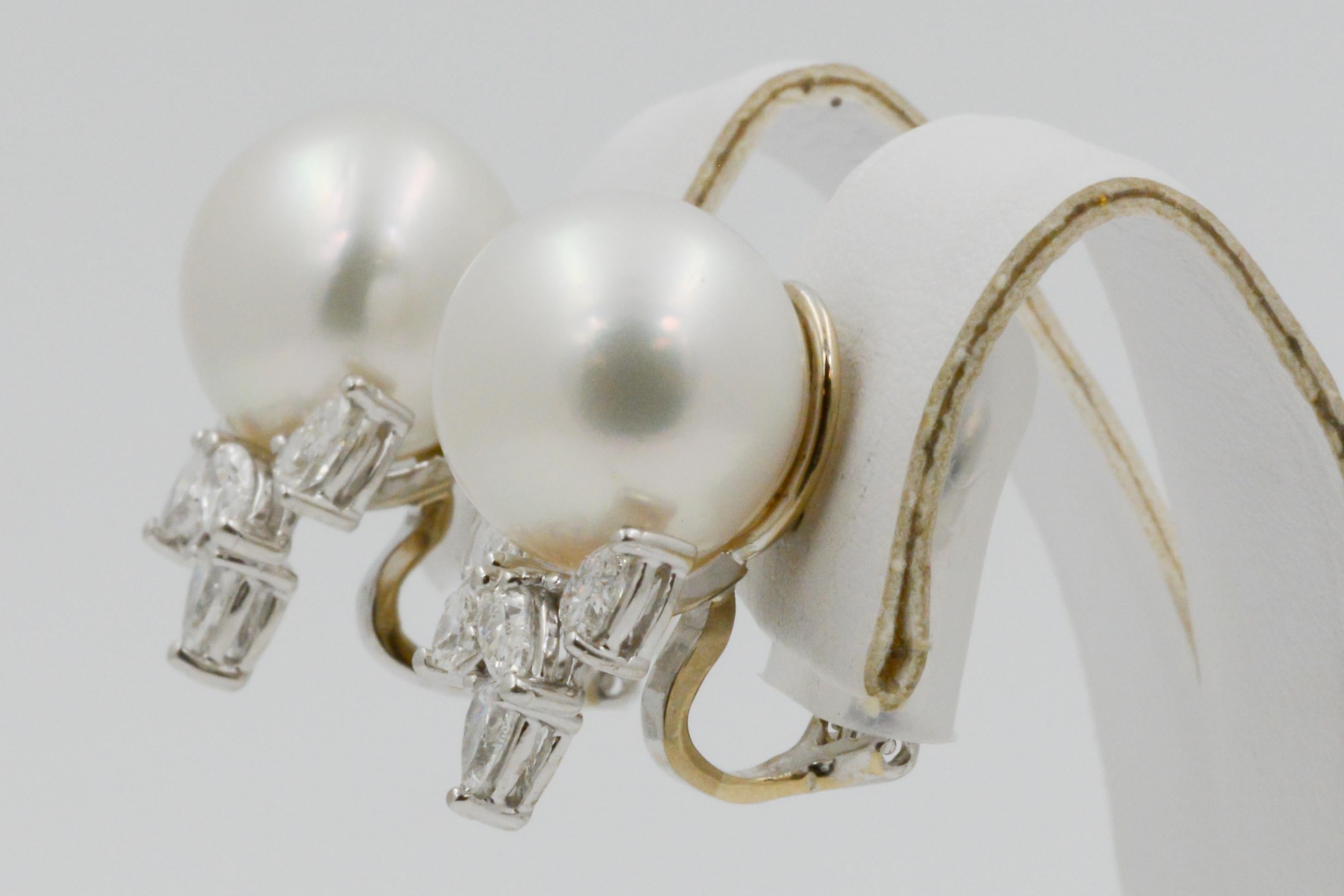 With elegant simplicity, these 18k white gold and south sea pearl earrings captivate a vintage charm. The pearls, measuring at 14.33mm are accented with 8 pear shaped and two marquise diamonds, weighing a total of 2.50 carats and having GH VS. The