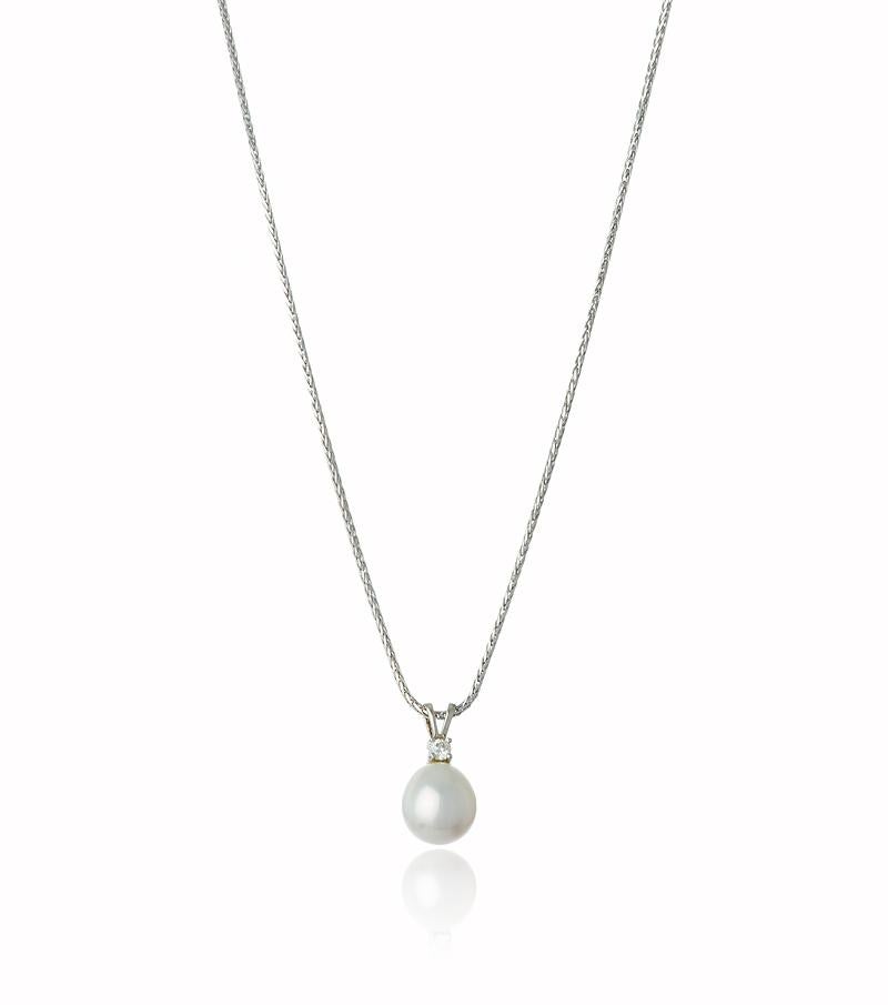 18k White Gold Pearl and Diamond Solitaire Pendant featuring a beautiful white South Sea Pearl measuring 10-11mm.
The rich white luster is illuminated by  sparkling white diamond delicately set above. 

The Pearl is slightly out of round on shape,