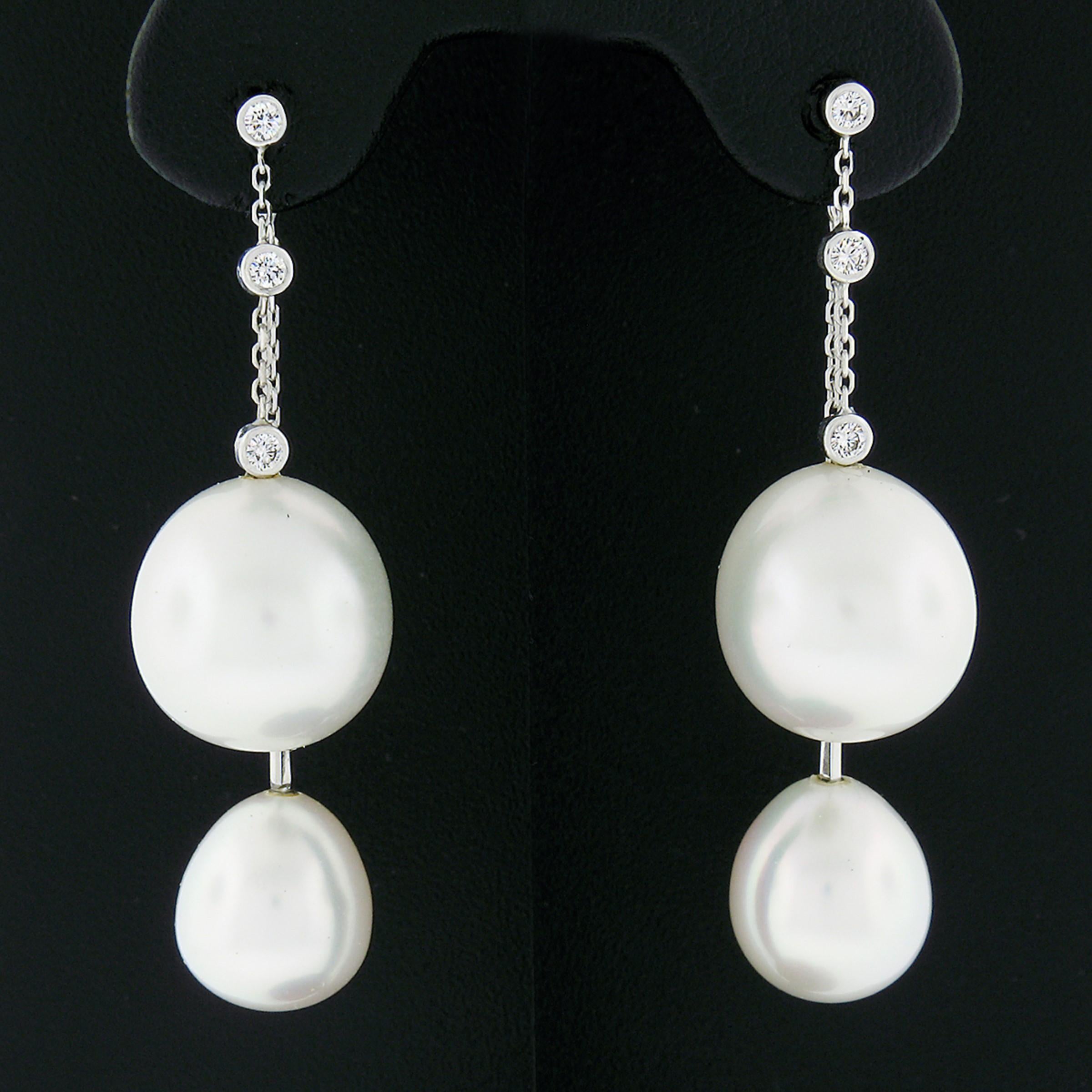 Here we have an absolutely gorgeous pair of earrings that is crafted from solid 18k white gold and feature a wonderful drop dangle style that carries fine round brilliant cut diamonds with beautiful south sea pearls freely dangling at their bottom.