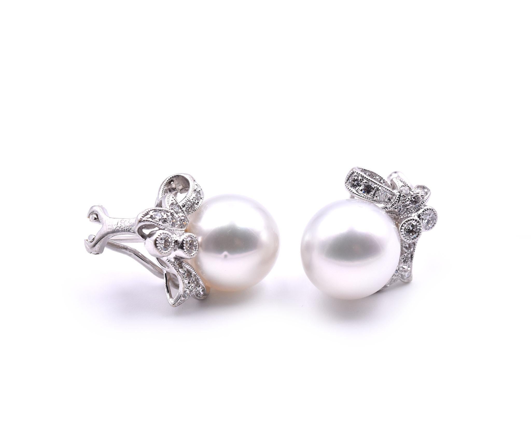 Designer: custom design
Material: 18k white gold
South Sea Pearls: 2 pearls approximate diameter is 12mm
Diamonds: round brilliant cut= .25cttw 
Color: G
Clarity: VS
Fastenings: post with Omega backs
Dimensions: each earring is approximately 18.45mm