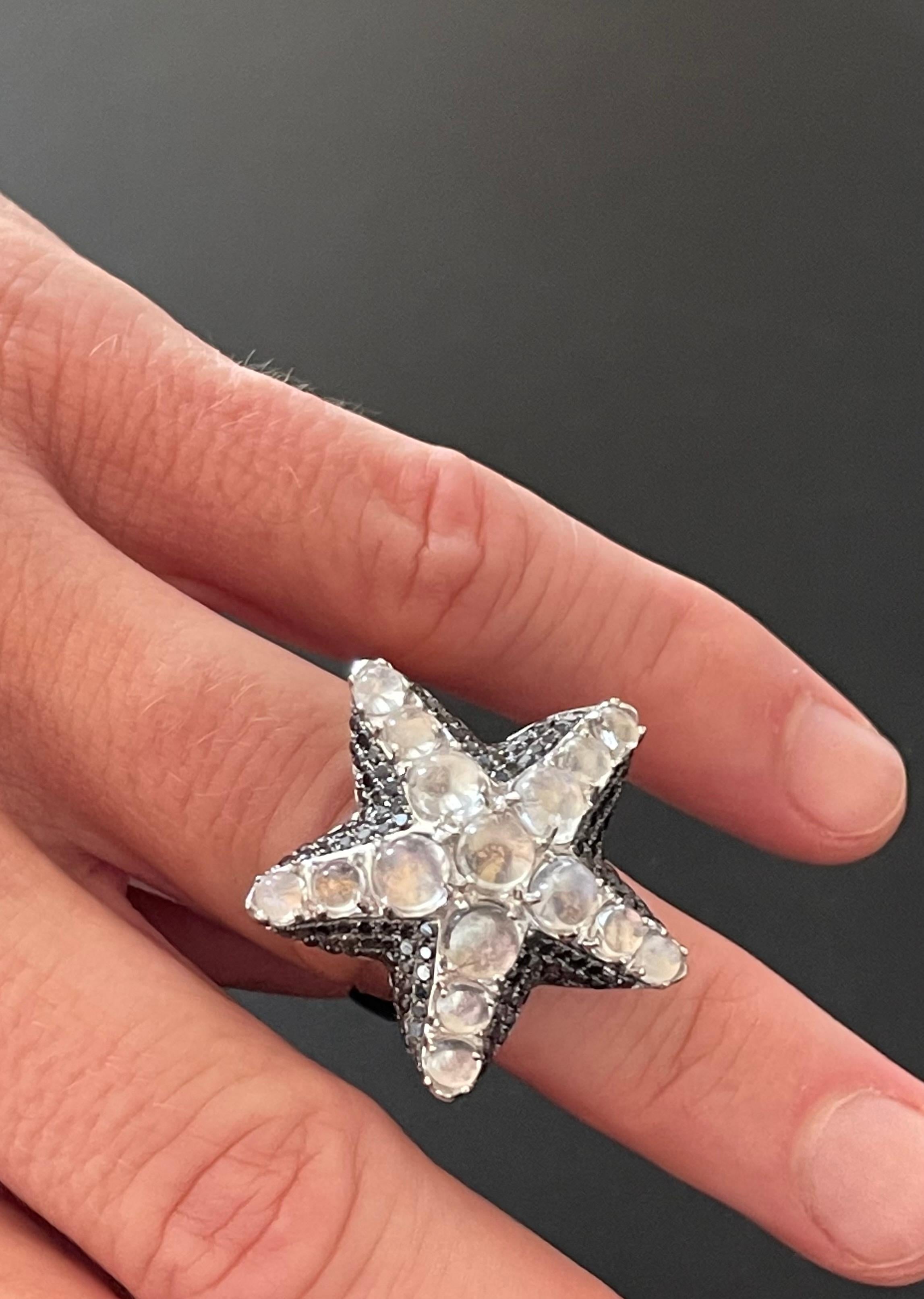 18 K white Gold Starfish Ring featuring 16 Moonstone Cabochons weighing 5.13 ct, framed by 134 black Diamonds with a tortal weight of 1.51 ct. 
The mystic alallure of this ring is simply captivating. The moonstones exhibit a blueish silvery rainbow
