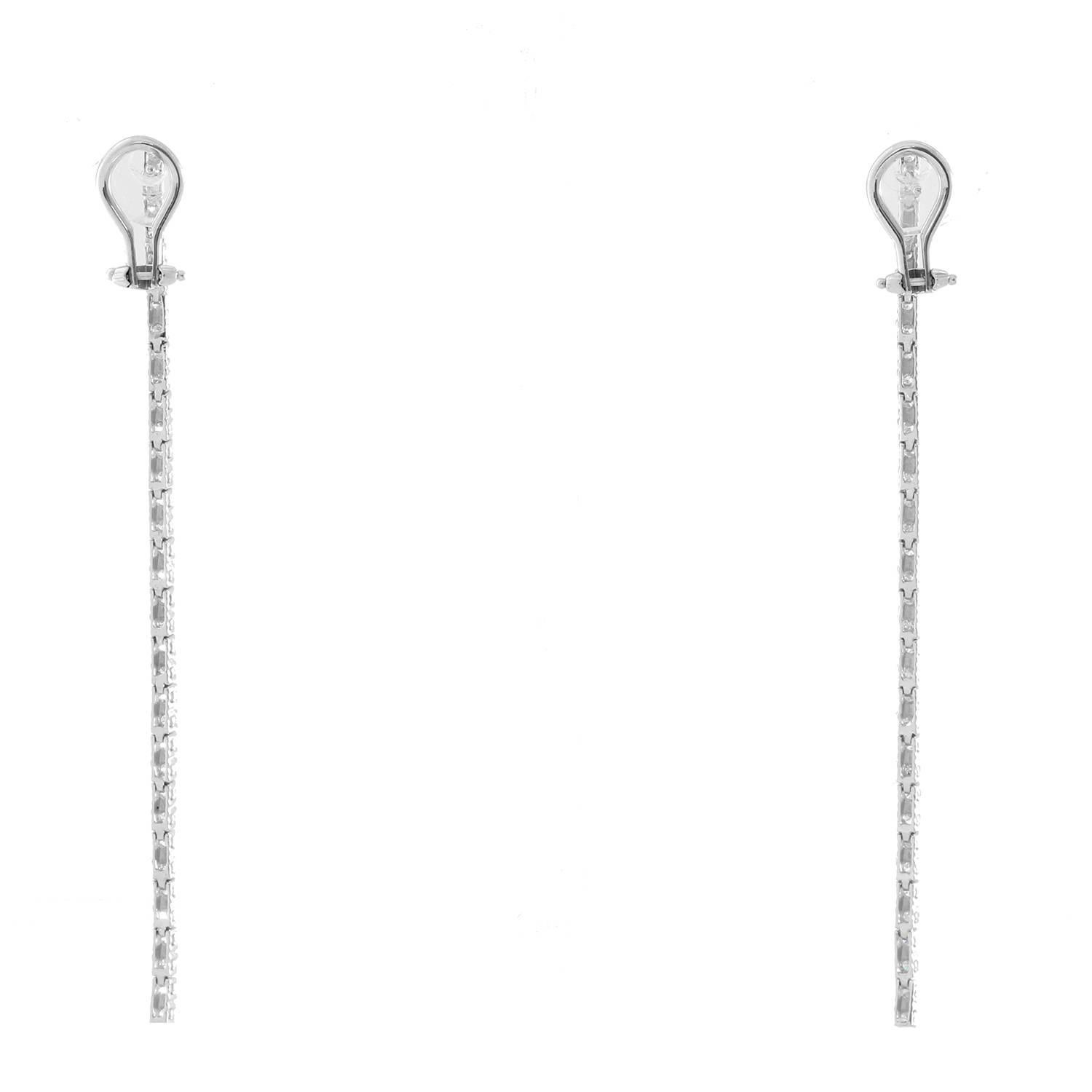 18K White Gold Straight Line Dangle Diamond Earrings - . Stunning one row dangle earrings. Round brilliant diamonds totaling 1.11 ct. Clarity I1, Color G. Total weight 6.8 grams. 3 inches from top to bottom.