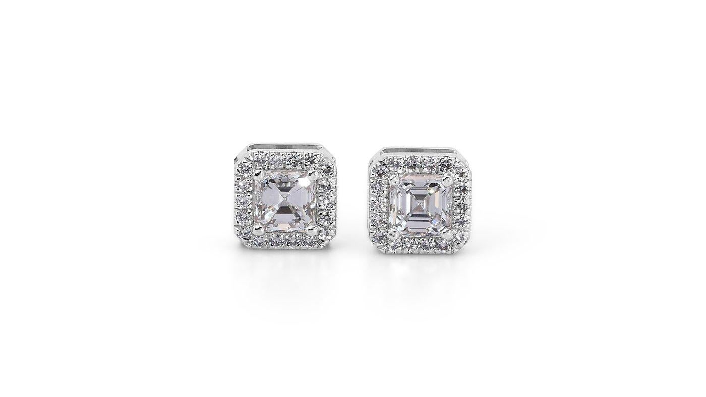 A charming pair of earrings with a dazzling 1.47 carat square emerald cut natural diamonds. It has 0.23 carat of side diamonds which add more to its elegance. The jewelry is made of 18k white gold with a high-quality polish. It comes with GIA
