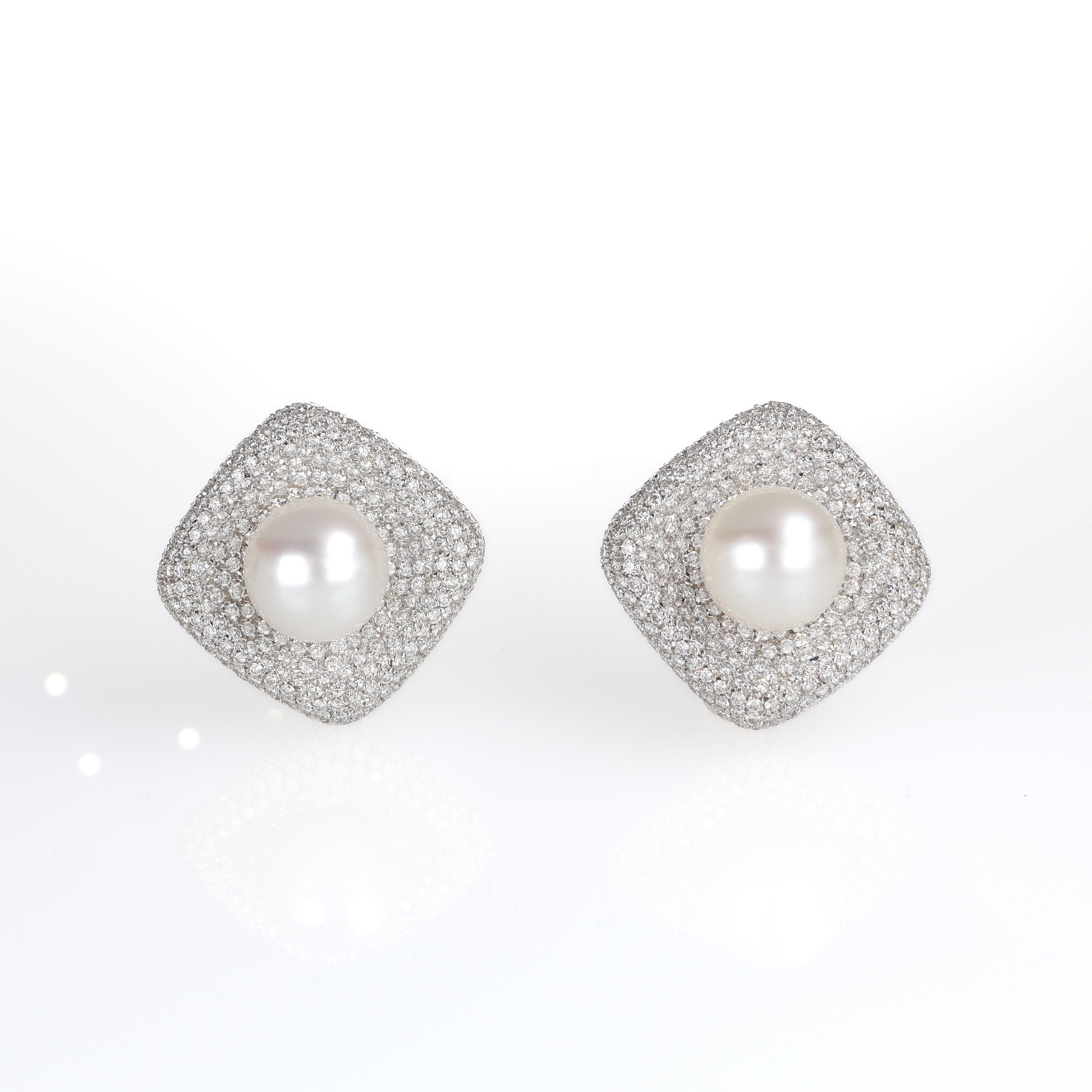 Refined 18K white gold stud earrings, featuring a radiant pave setting of brilliant-cut diamonds totaling 7.80 carats. At the center of each earring, a luminous pearl adds a touch of timeless sophistication. A bold yet elegant statement piece,
